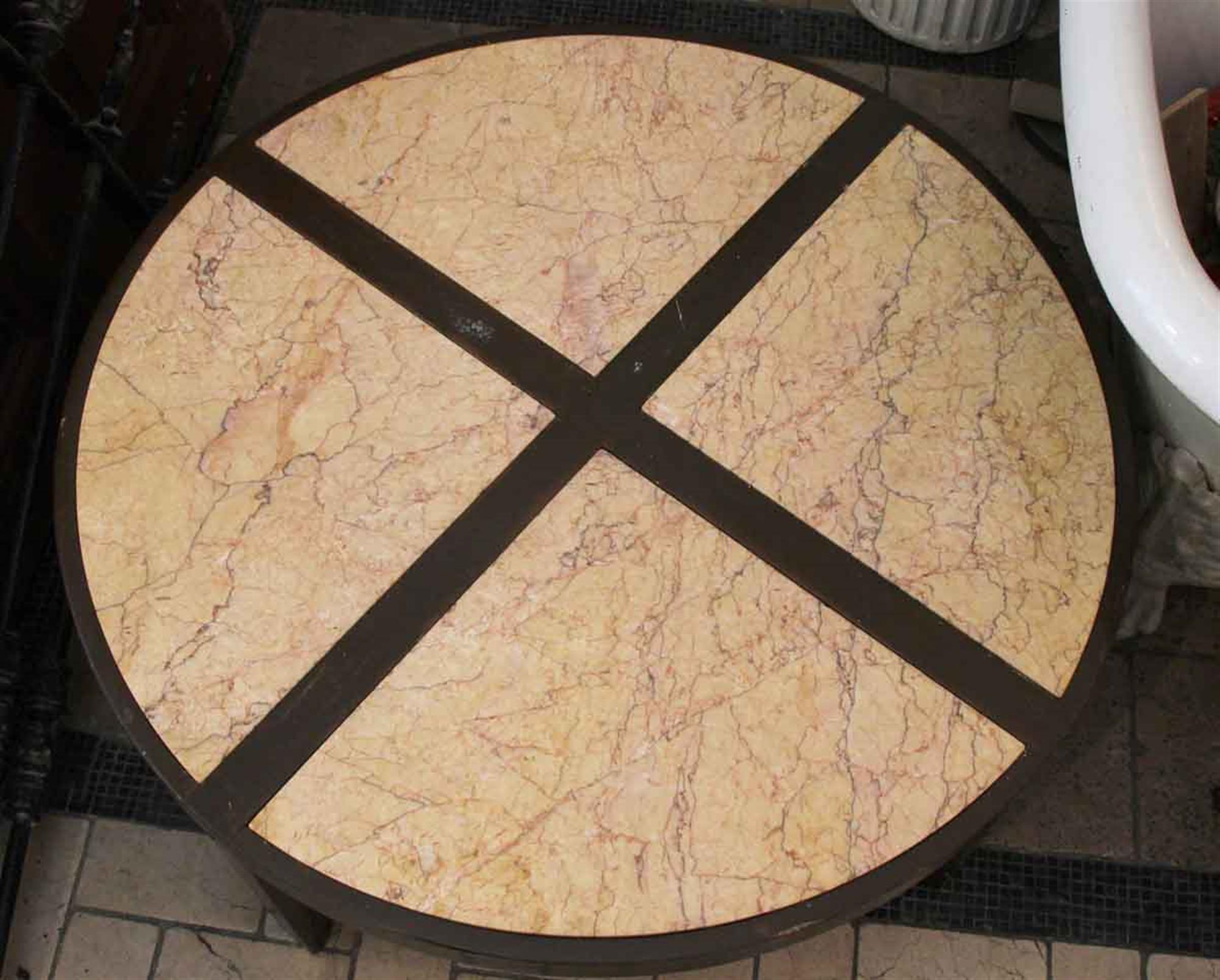 1950s dark wood tone Mid-Century Modern round coffee table with a four section marble top. Some minor wear from use. This can be seen at our 5 East 16th St location on Union Square in Manhattan.