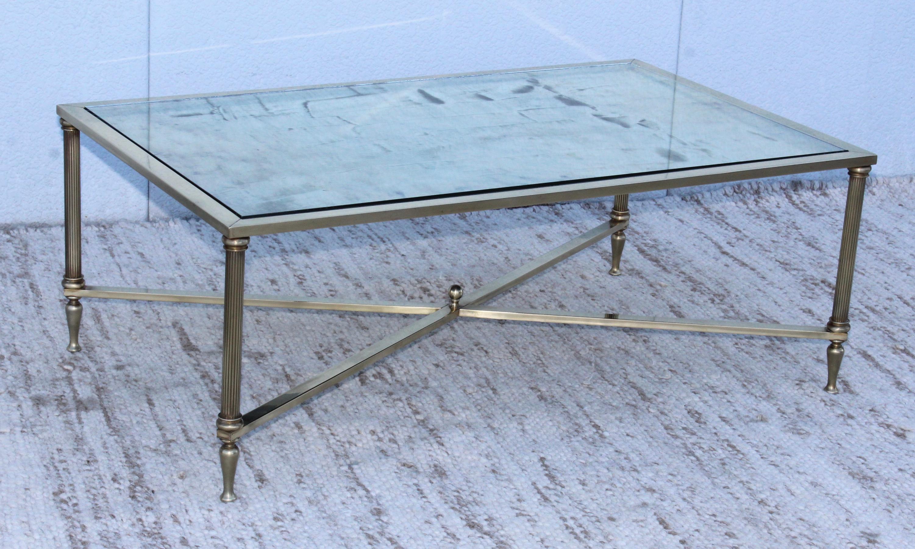 1950s modern solid brass French coffee table with antique mirror top.