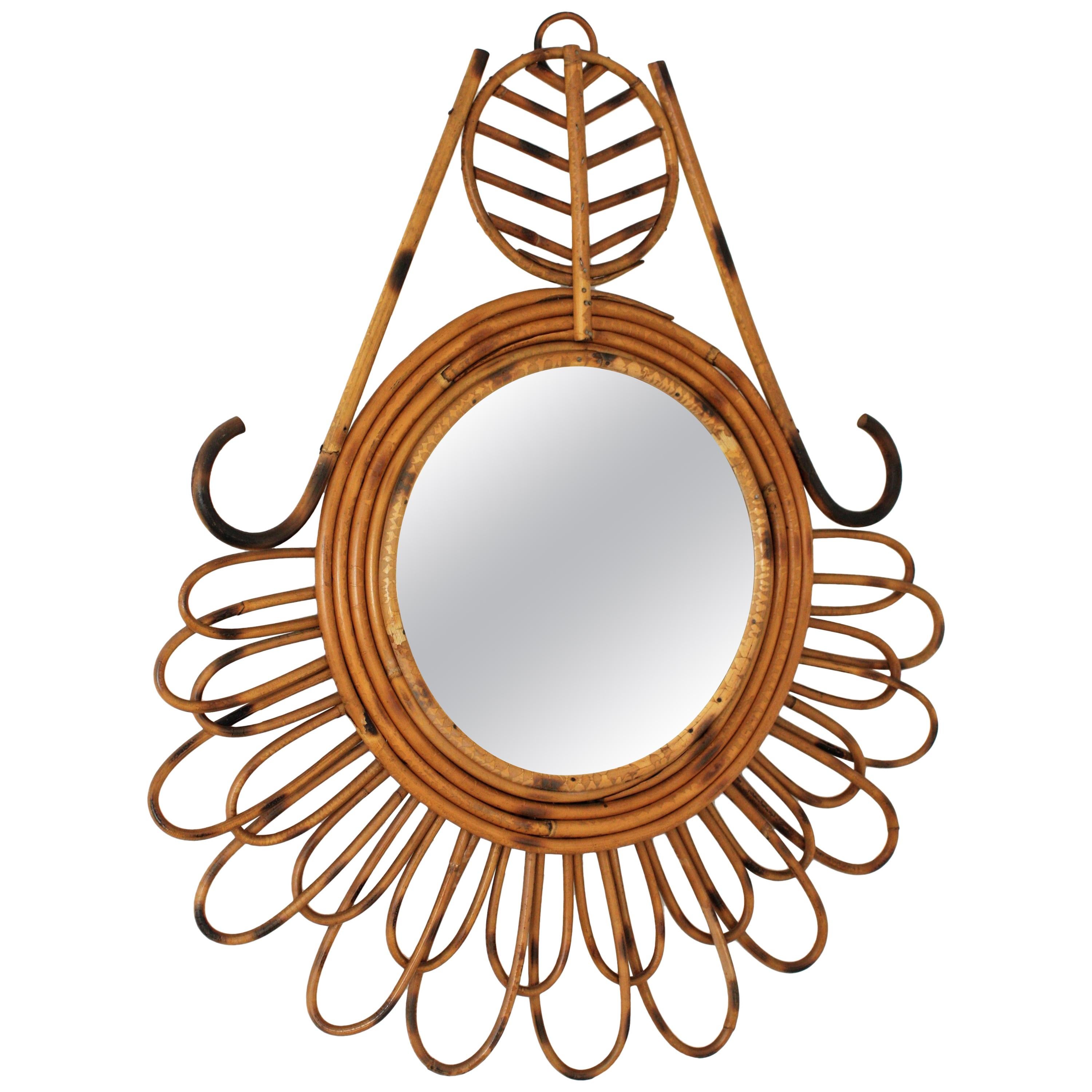 Unique Mediterranean style handcrafted rattan abstract mirror, France, 1950-1960.
This mirror has rattan petals in two sizes, an abstract decoration adorning the frame and five rattan loops surrounding a circular glass.
Dimensions of the glass: