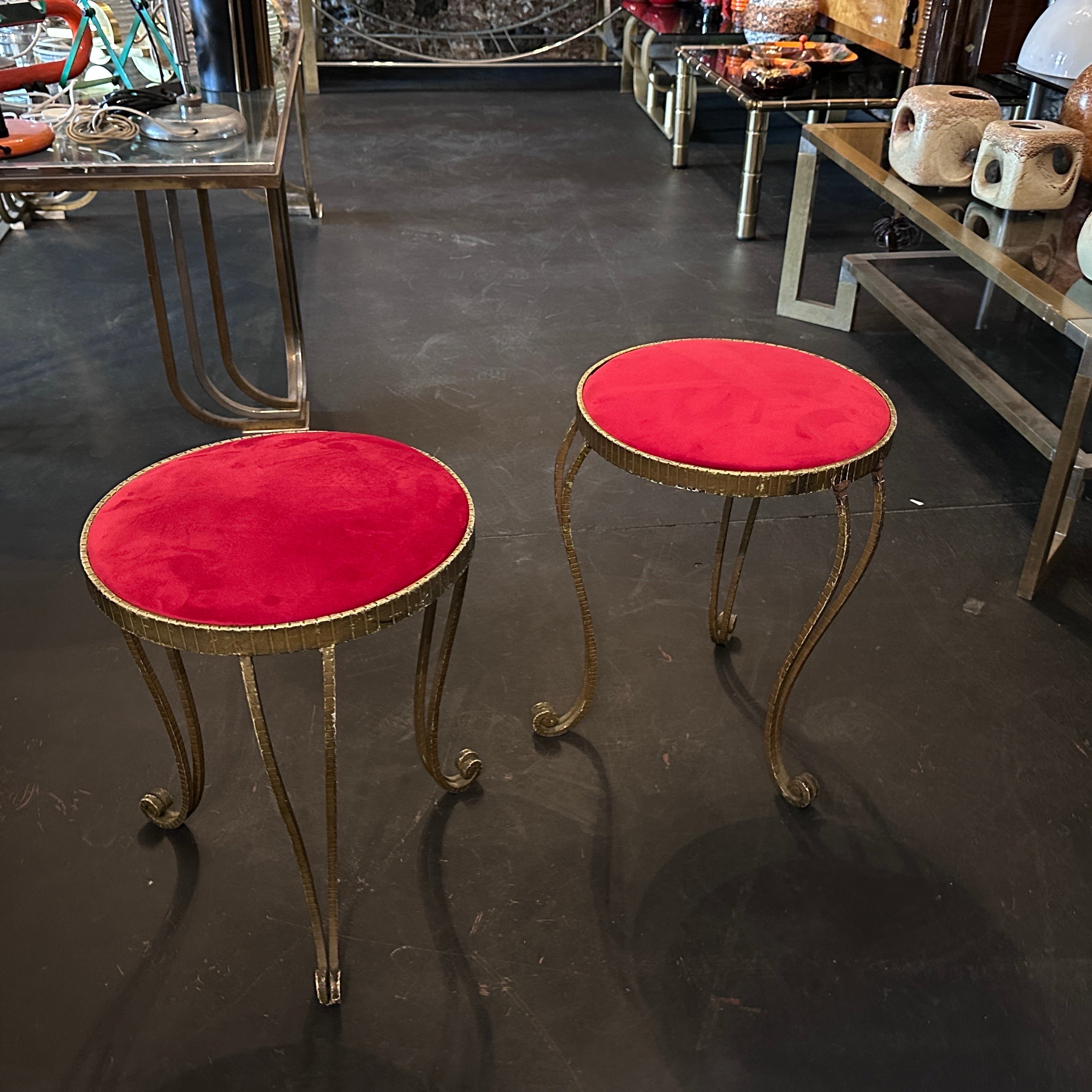 Two gilded iron and red velvet stools designed by Pier Luigi Colli and manufactured in Italy in the Fifties in good conditions. the Stools by Pier Luigi Colli are a pair of exquisite seating pieces that exemplify the luxurious and artistic design of