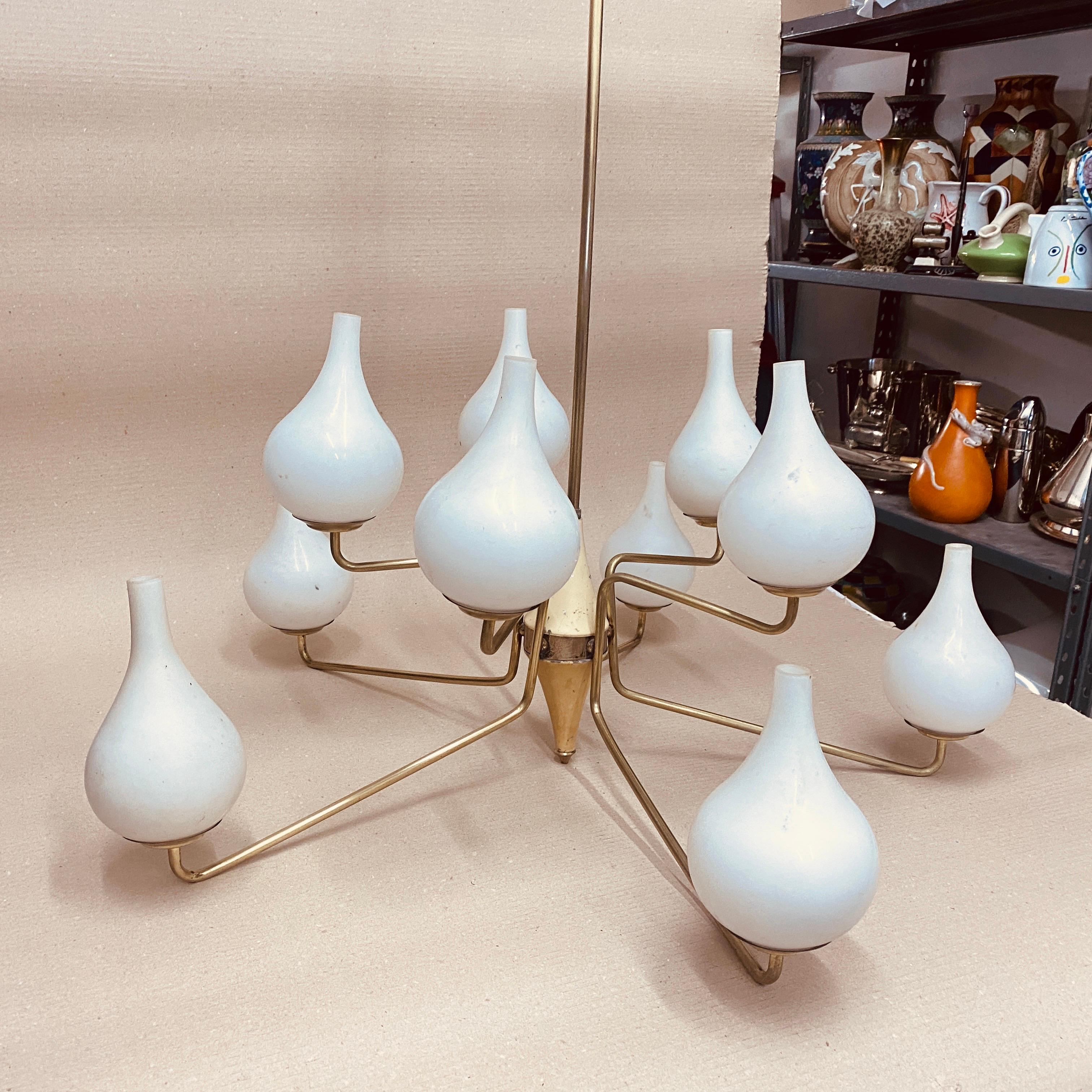A brass and white opaline glass Mid-Century Modern big chandelier, due to bad conditions, brass it has been cleaned, white ivory painted metal it's in original conditions. The opaline glass diffusors are in perfect conditions. It works both 110-240