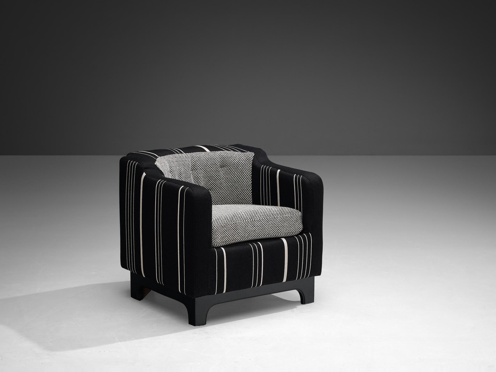 Armchair, fabric, lacquered walnut, Italy, 1950s

With its distinctive geometry and angular lines, this lovely club chair is the perfect embodiment of mid-century modern design. The armrests and backrest form a cohesive, enveloping structure, with a