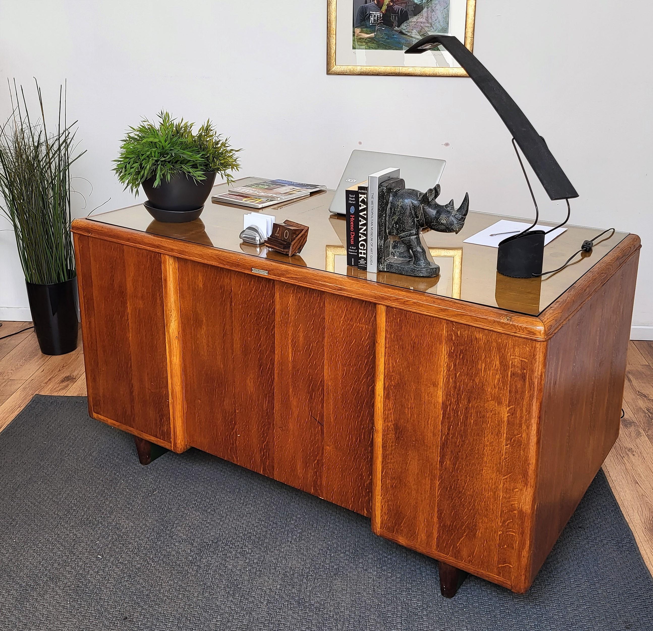 Very elegant Italian Mid-Century Modern desk writing table, with glass top and beautiful shape of the side and back, where we find the maker's details, Andrea Macchi fu Giosue in Gallarate, a village in the surroundings of the city of Milan. On the