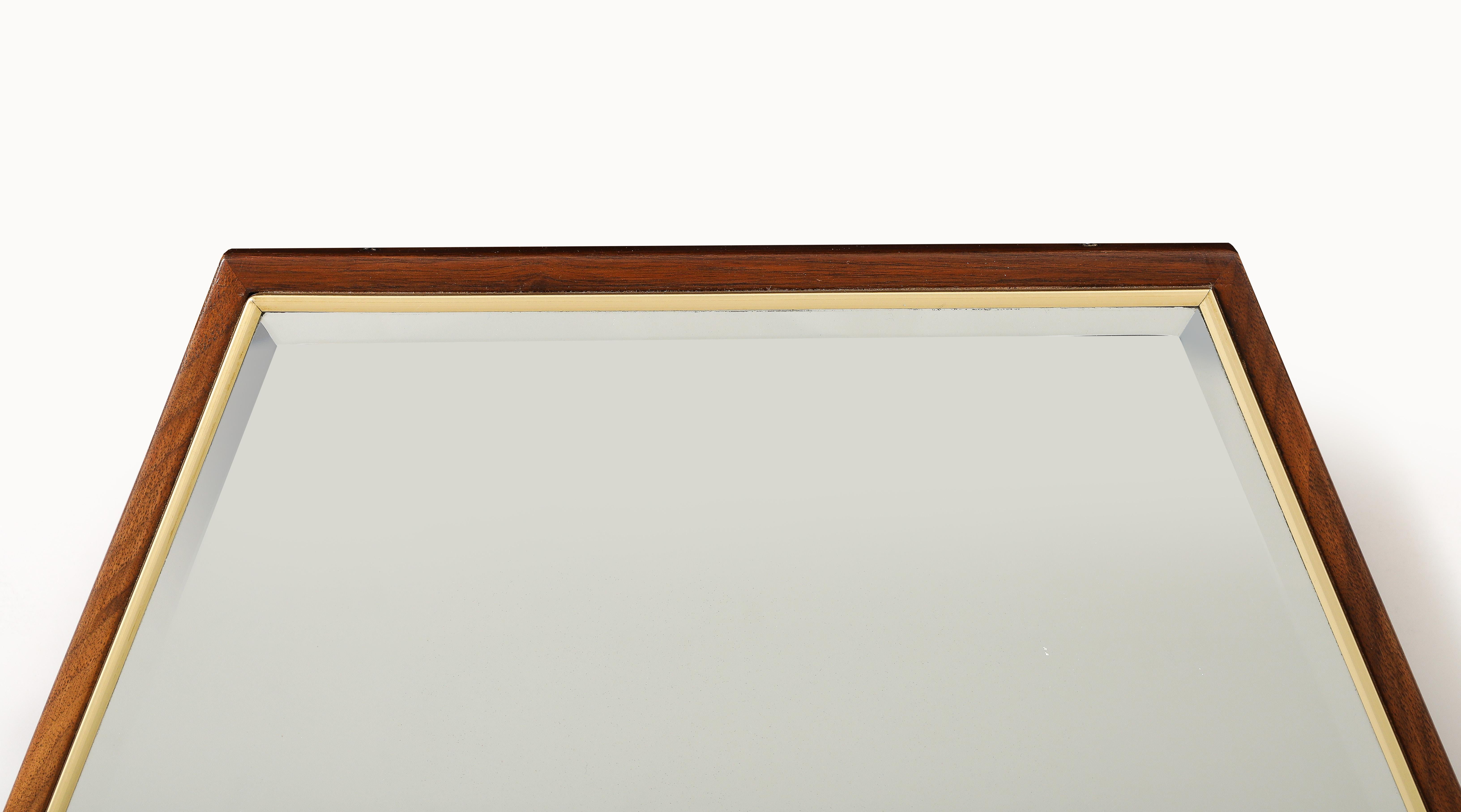 Stunning pair of 1950's large brass and walnut large octagonal wall mirrors, with beveled mirror fully refinished with minor wear and patina due to age and use.