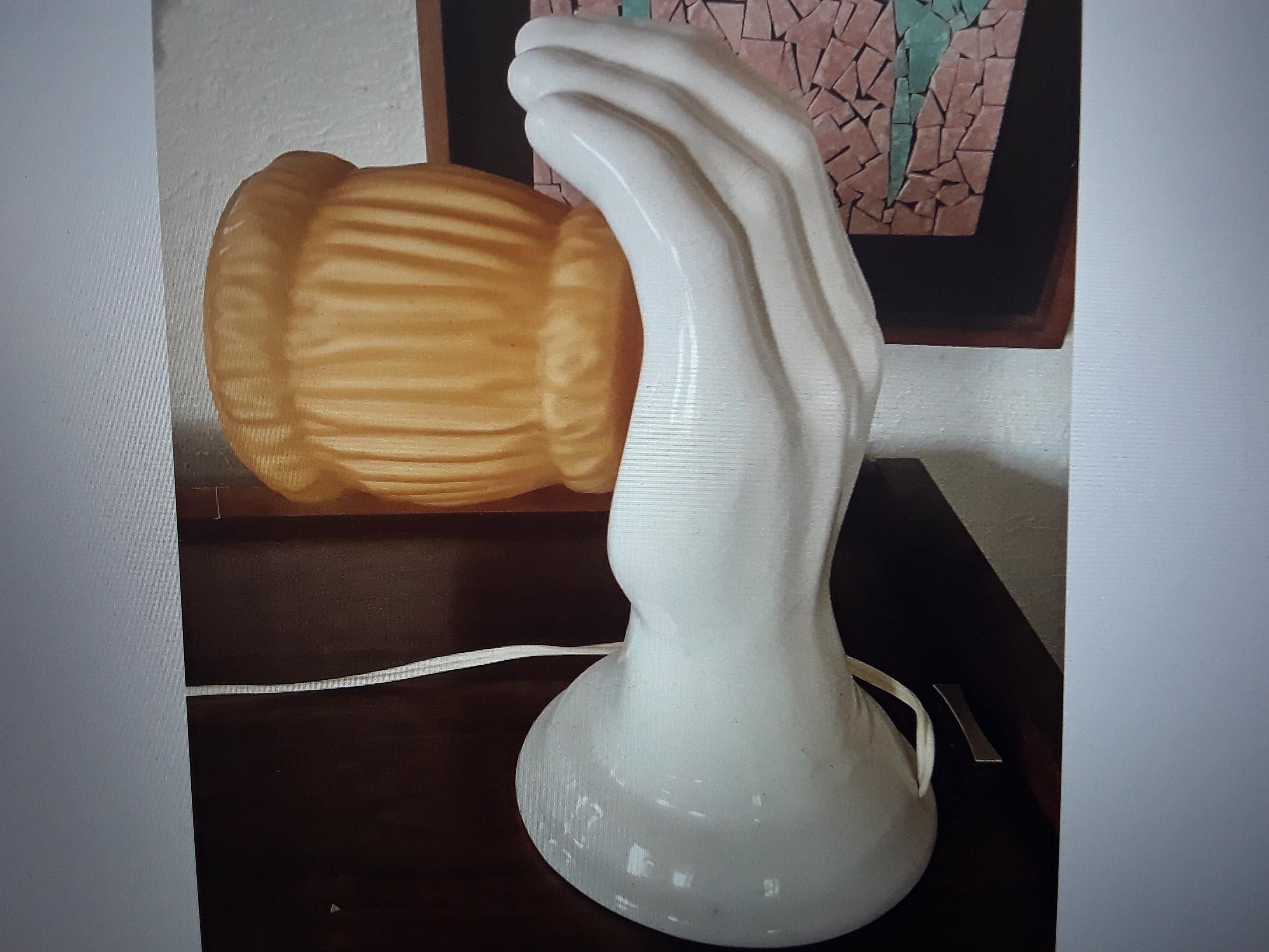 1950's Mid Century Modern White Glazed Ceramic Outstreched Hand Wall Sconce.  Amber tone shade. This is a large hand.