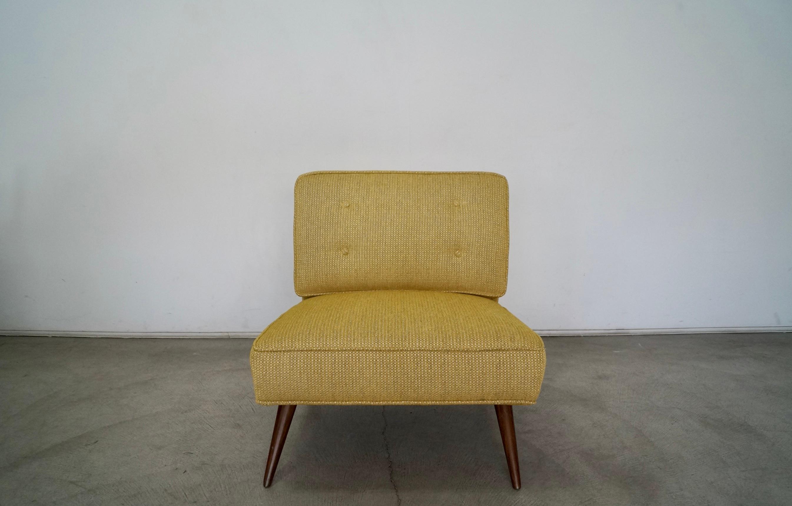 Vintage 1950s Mid-Century Modern lounge chair for sale. The legs have been professionally refinished in walnut, and it has been professionally reupholstered in new fabric and foam. The fabric is gold with a gray and white undertone that is