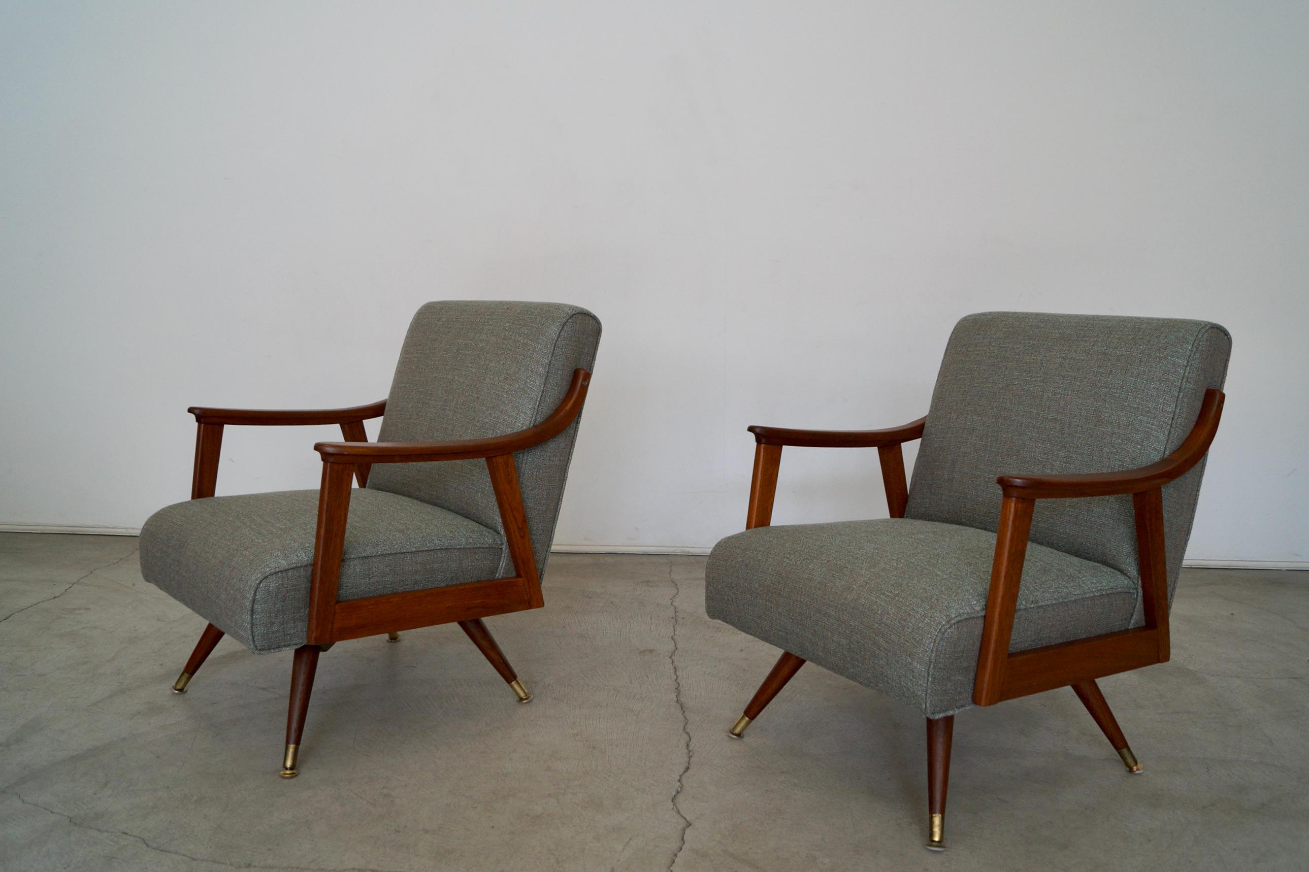 Pair of vintage 1950's Mid-Century Modern lounge chairs for sale. These have been beautifully restored. The frames have been refinished in walnut, and the chairs have been reupholstered in new fabric and foam. We selected a wonderful fabric by