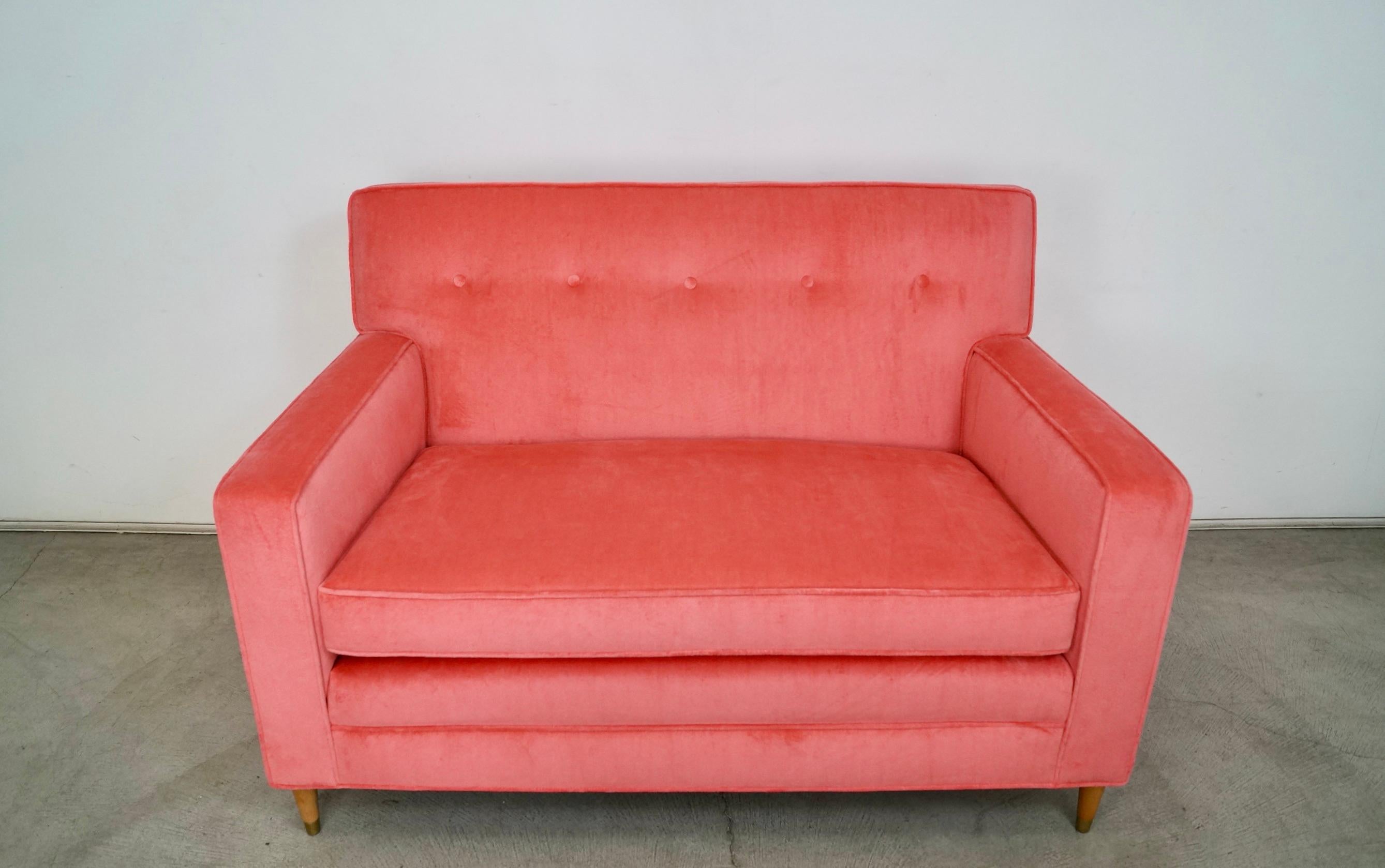 Gorgeous original Hollywood Regency Midcentury Modern settee lounge couch for sale. Manufactured in the 1950's, and has been professionally reupholstered in new velvet and foam. The legs are solid oak, and have been refinished in a natural oak tone.