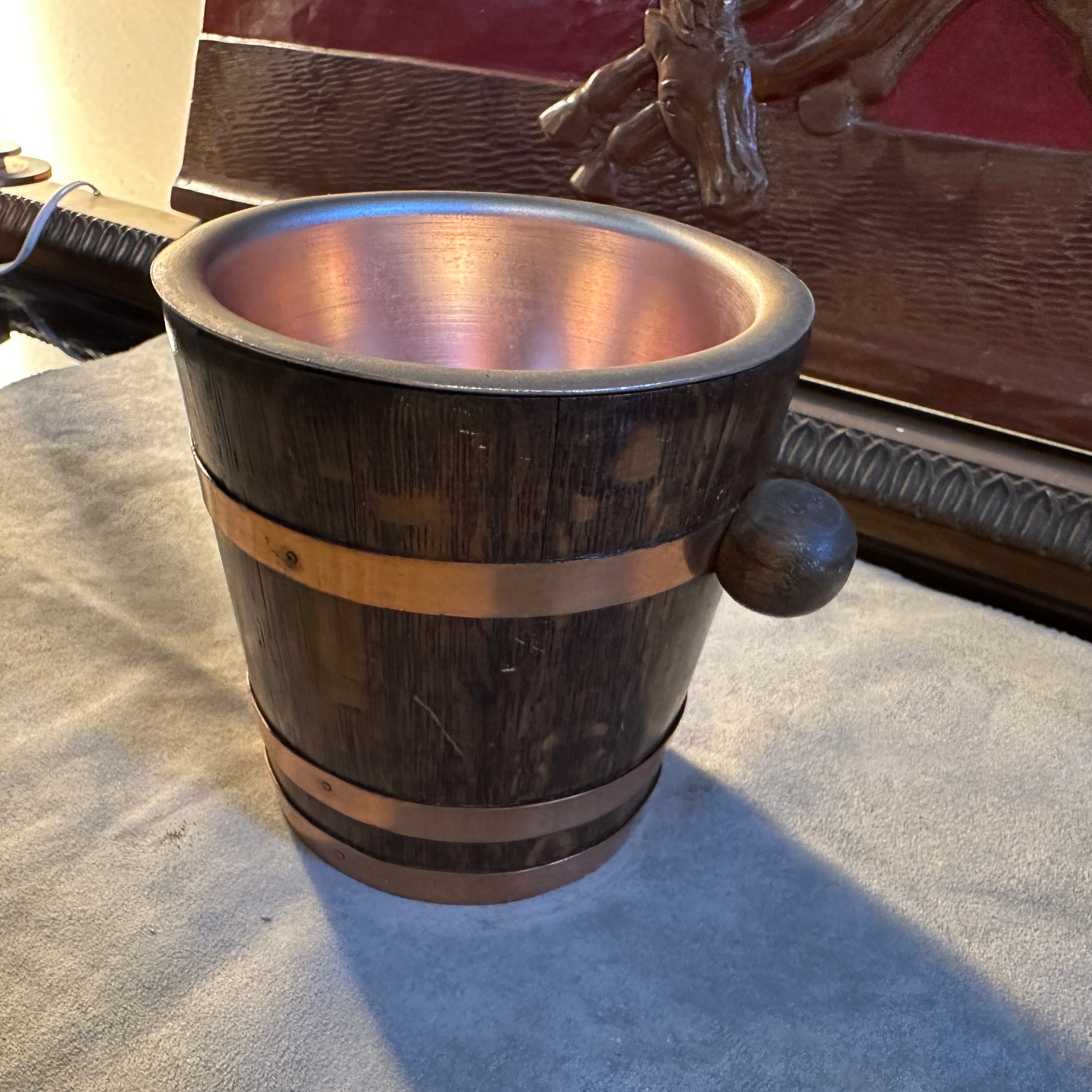 A superb oak and copper ice bucket designed and manufactured in France in the Fifties in the style of Geraud Lafitte. It's in original condition and patina, probably it hasn'' been never used. The ice bucket exhibits characteristics of Mid-century