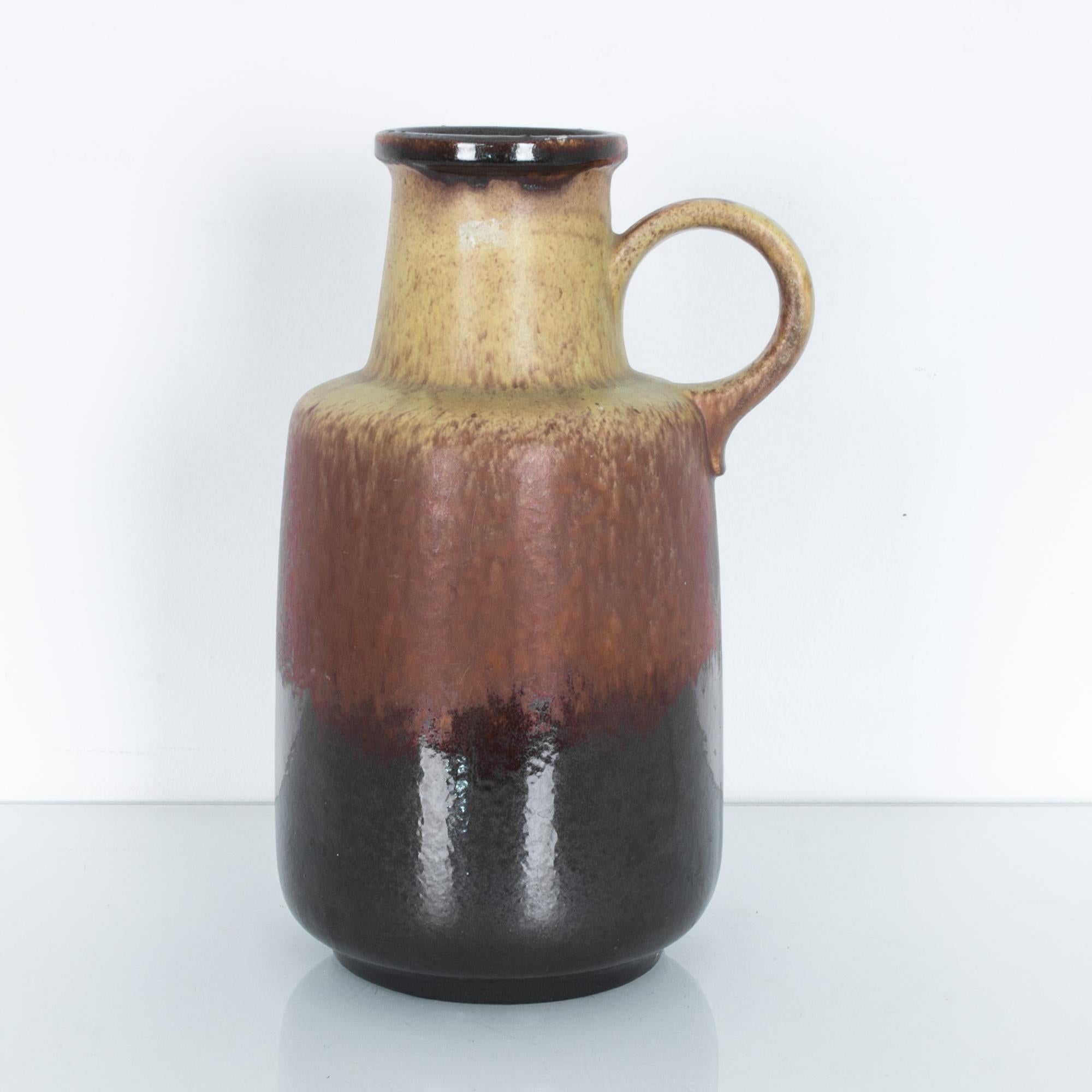 A ceramic vase from Germany, circa 1950, in evocative layers of oxidized color, stamped underneath with the production series and “W. GERMANY” mark. These characteristic mid-20th century ceramics were produced in West Germany by a range of makers.