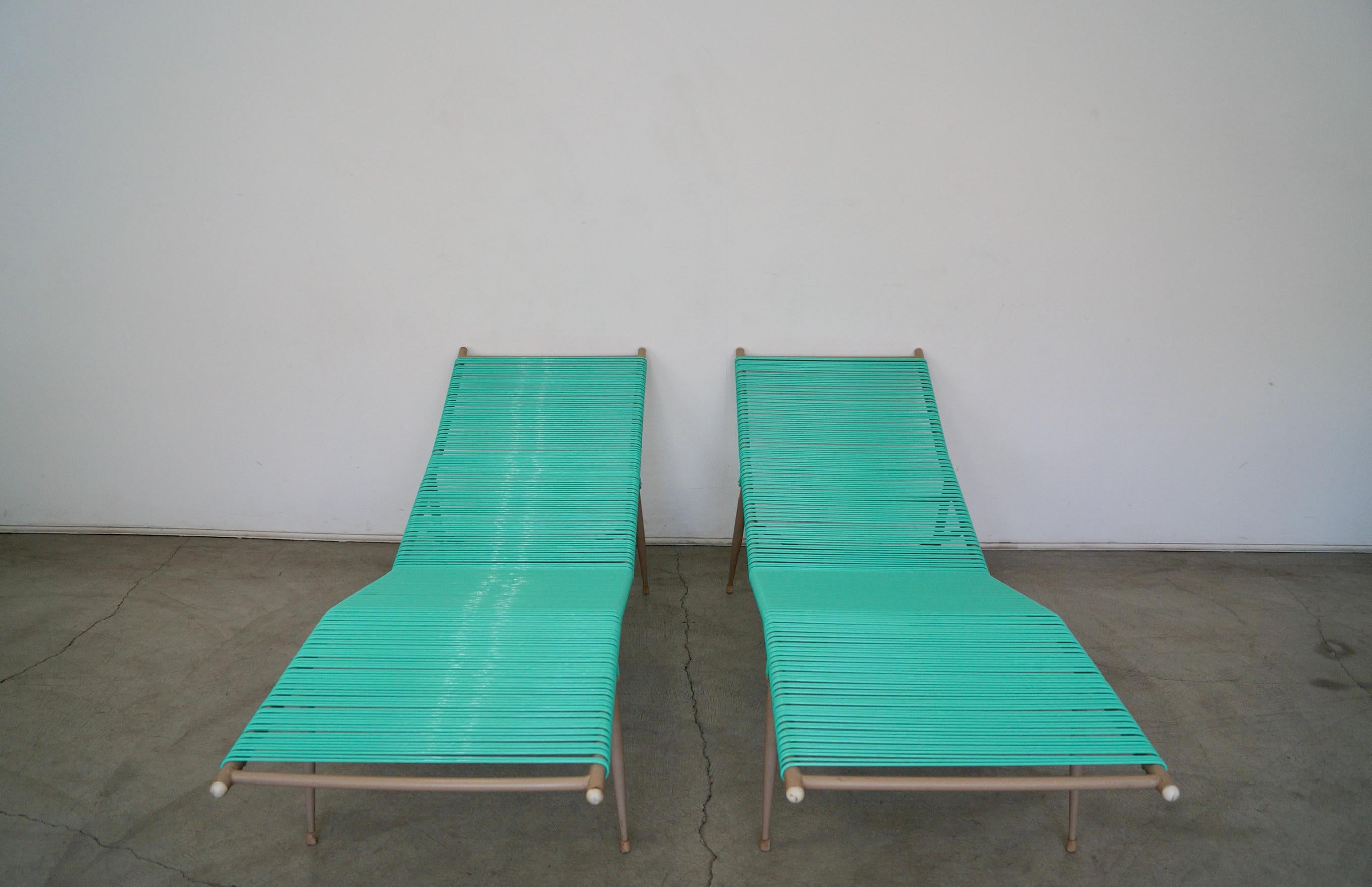 Pair of original Mid-Century Modern outdoor chaise lounge chairs for sale. From the 1960's, and have been newly wrapped with teal vinyl cording. The frames have the original finish and are in excellent condition. The teal and grayish metal finish