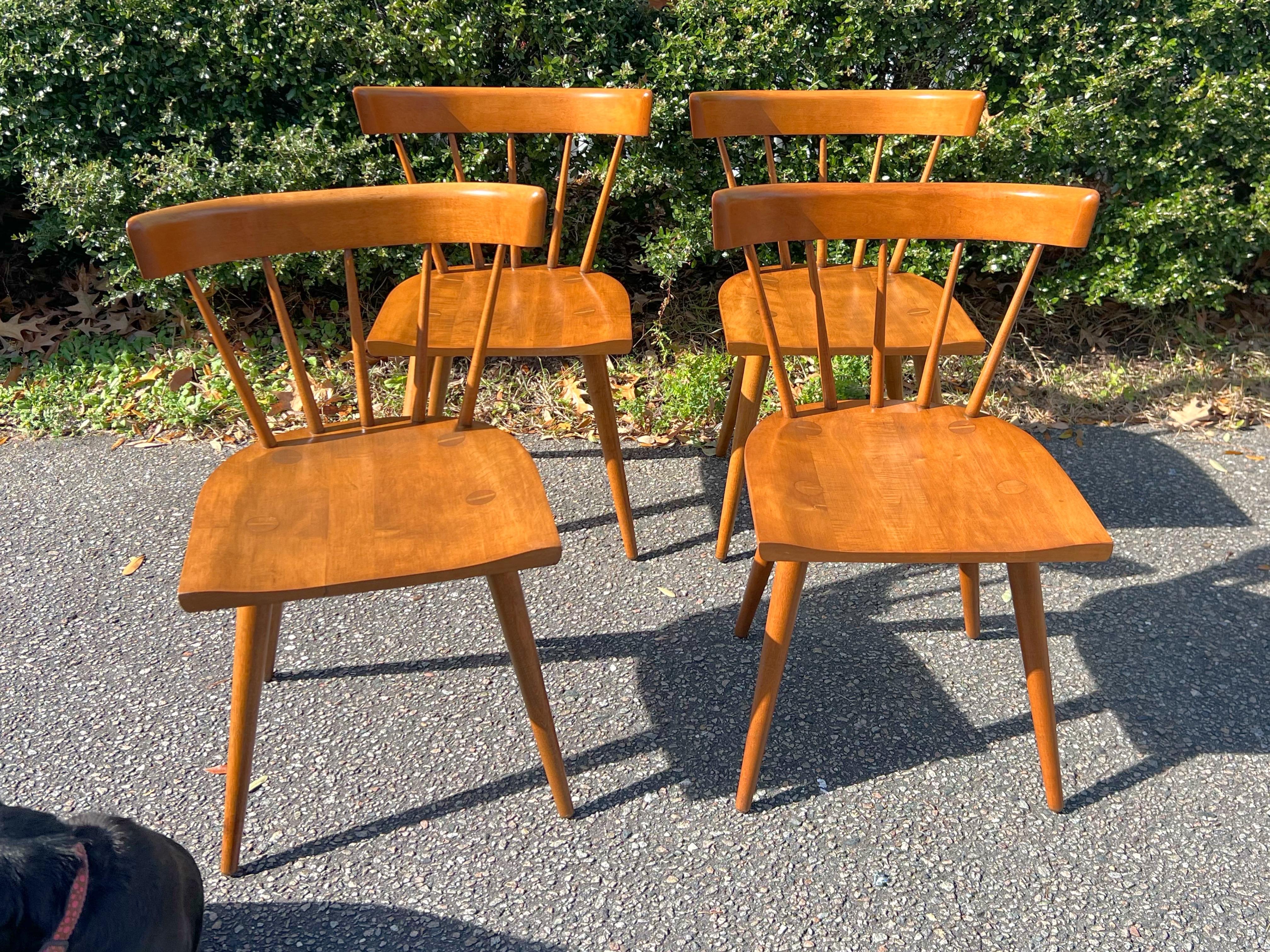A set of four dining chairs Designed by Paul McCobb's iconic for Winchendon Furniture Planner Group series, manufactured from 1950-1964.   These chairs have been professionally restored.    When they were being stripped, the tagged signature on the