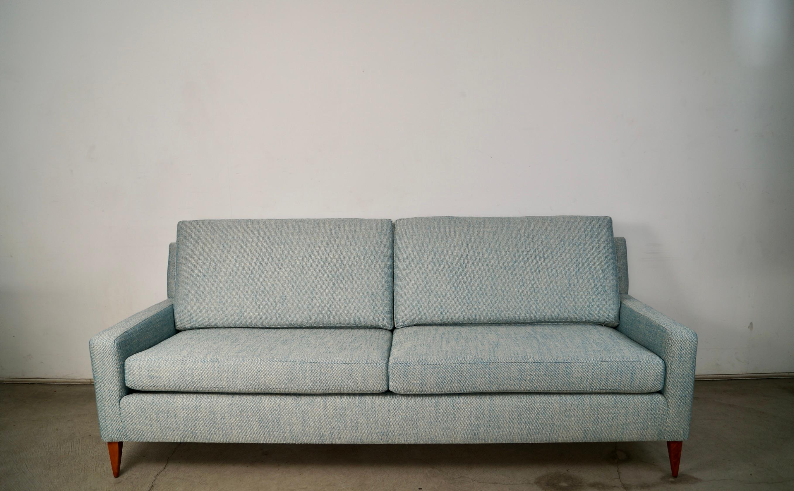 Vintage Midcentury Modern sofa for sale. Designed by Paul McCobb in the 1950's, and part of the Planner Group series. This couch was professionally restored, and is in showroom condition. The legs were refinished in walnut, and it was reupholstered