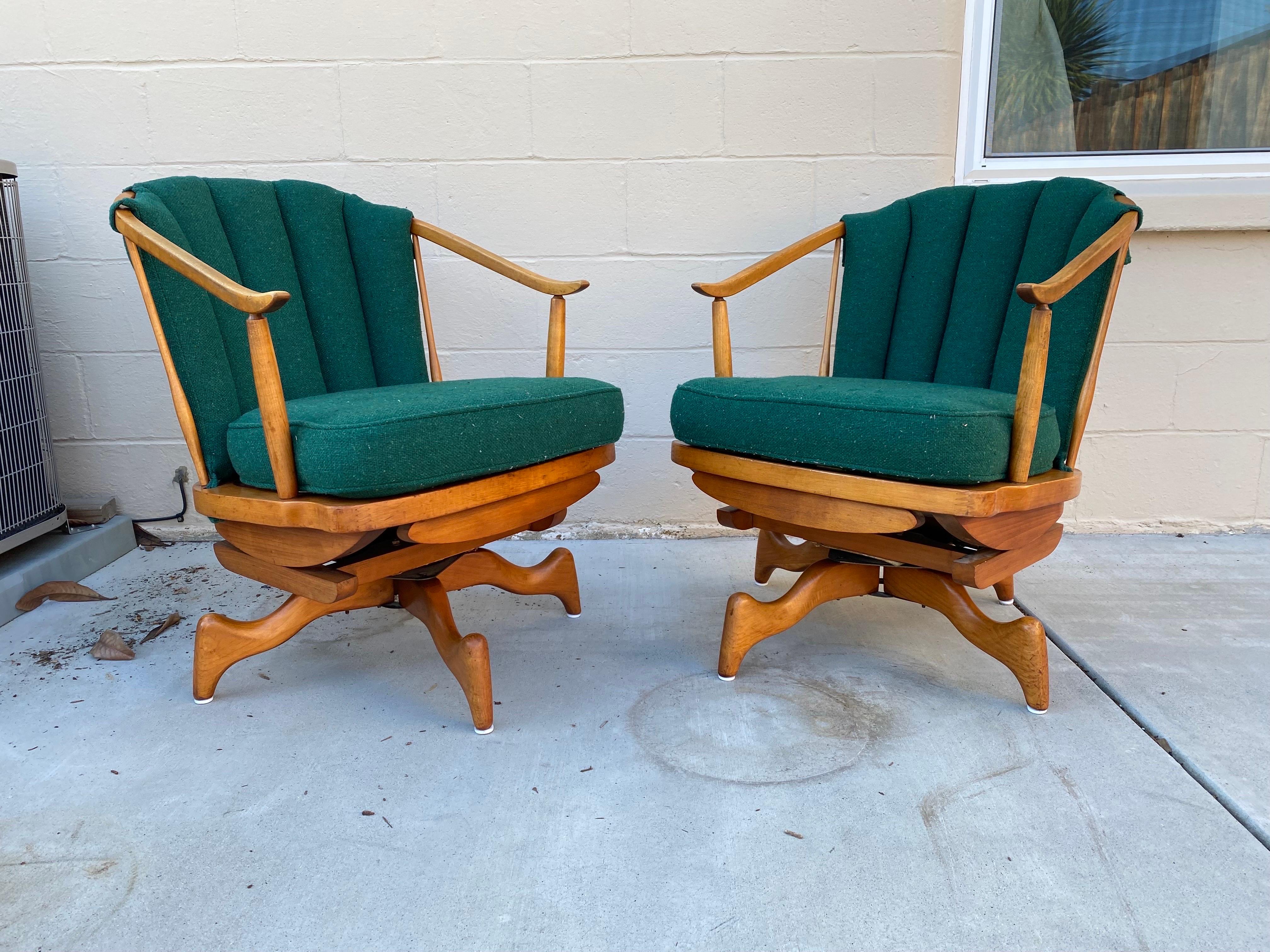 Cool set of 2 Mid-Century Modern platform spring rocking chairs with spindled barrel back. Produced in the 1950s, these rocking chairs in Birch (?) come with their original green upholstered cushions and are reminiscent of the great Mid-Century
