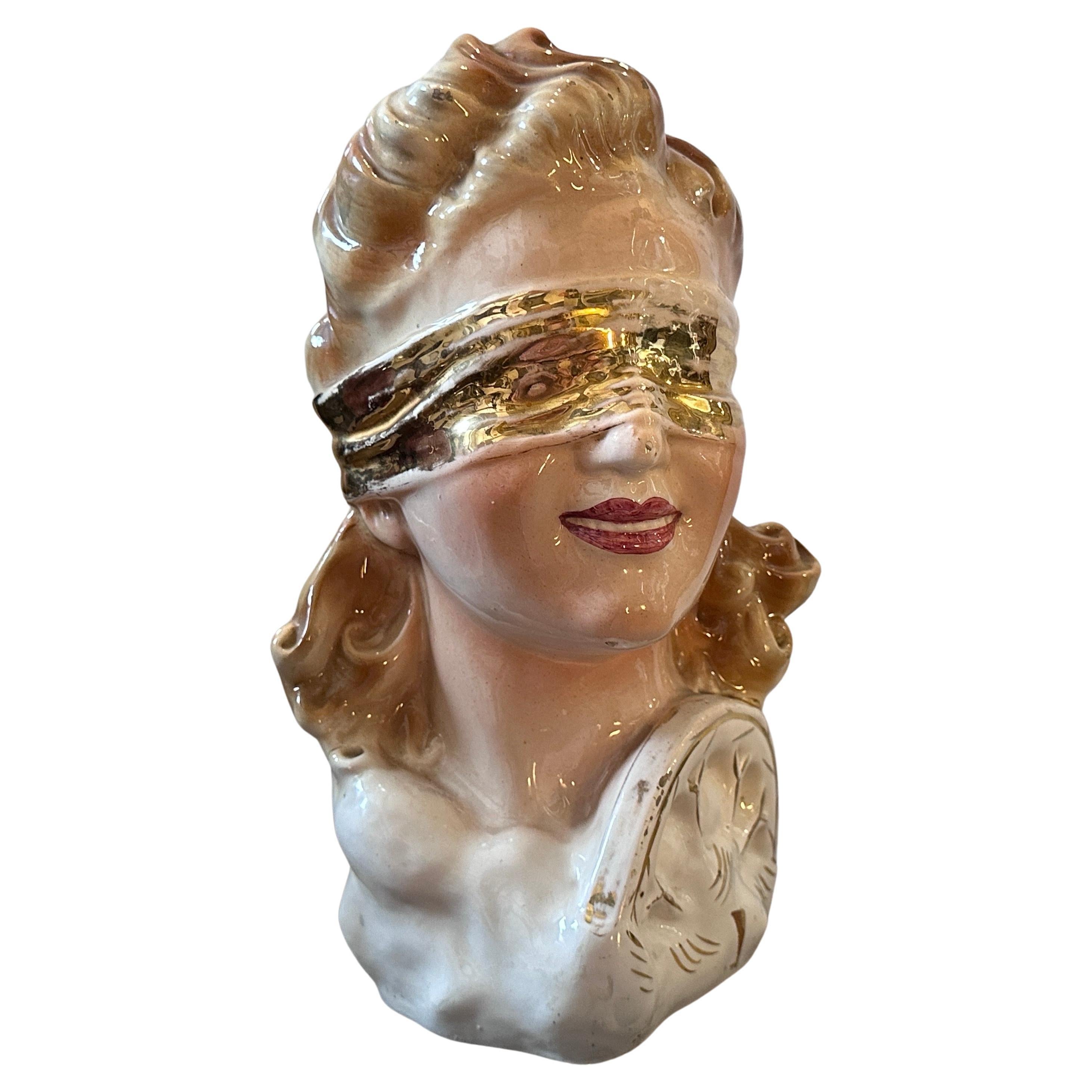 A mid-century modern ceramic bust of the blindfolded goddess synonymous with luck manufactured by Ceramica Artistica Punziano in  Naples in the Fifties in original conditions with normal signs on the glaze. it's marked on the bottom and labeled with