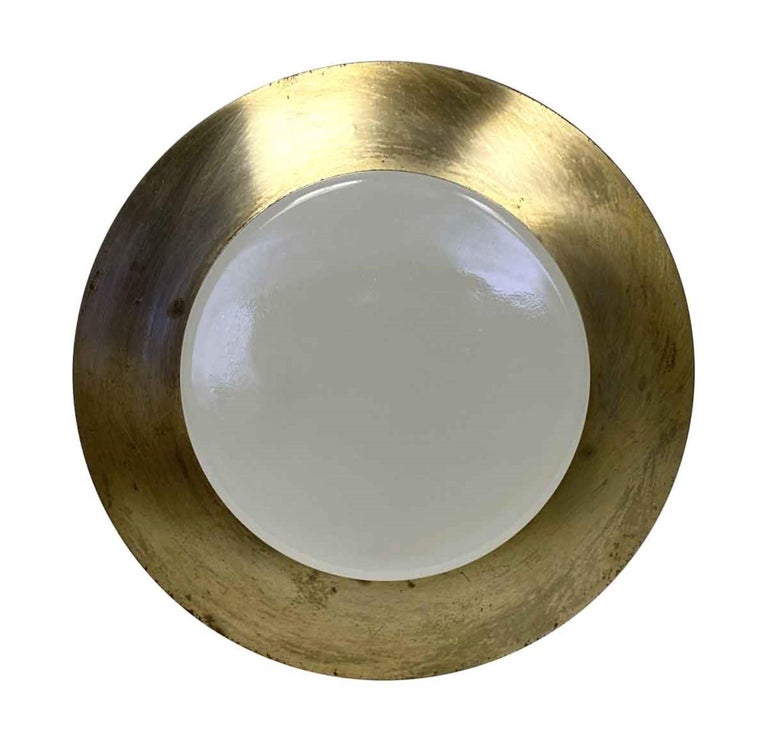 This is for the light cover only. Socket section not included.

1950s brass plated steel frame with a thick milk glass lens. There is some wear in the brass finish where the steel shows through. This is a light cover for a 6 in. recessed light. The