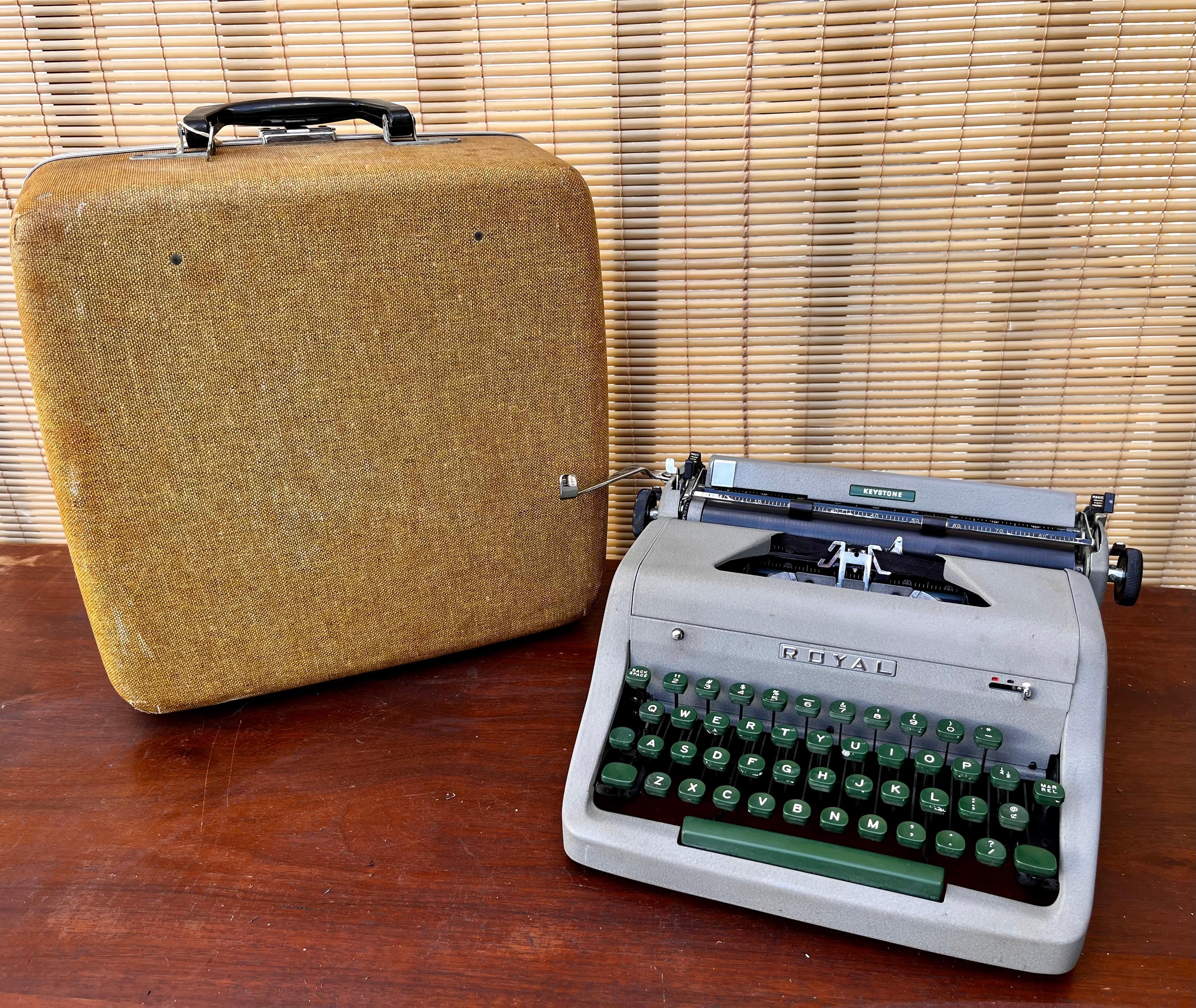 Vintage Mid-Century Modern Royal Keystone portable typewriter with original case. circa 1950s. 
Features a Qwerty keyboard, a gray color body green keys, and the original case with the original lock key.
In excellent original cosmetic and working