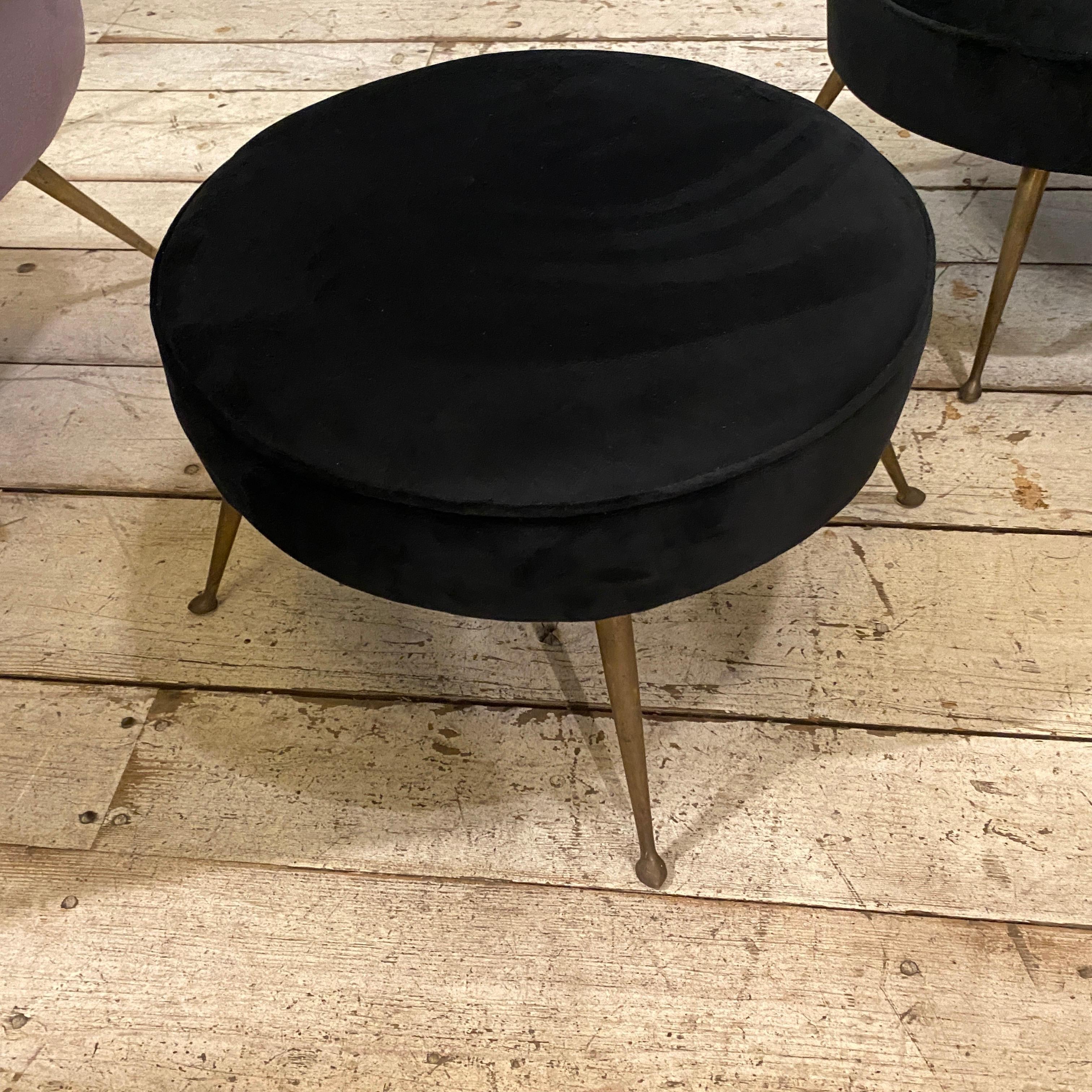 Two round poufs made in Italy in the Fifties, black velvet has been recently upholstered, brass it's in original patina.