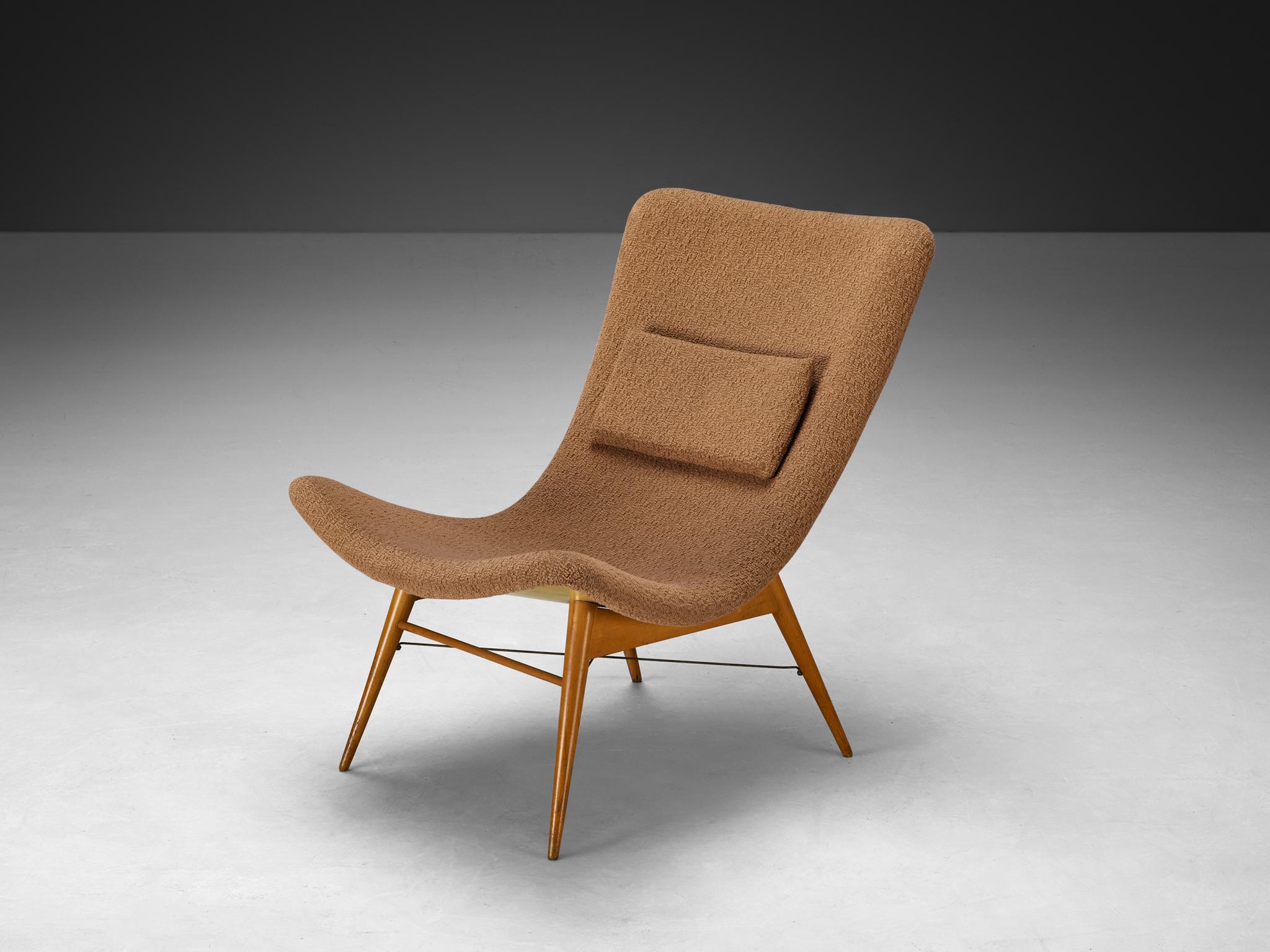 Lounge chair, fabric, beech, steel, lacquered laminated wood, Czech Republic, 1950s

This chair embodies many of the defining characteristics of 1950s modern furniture design, particularly its smooth, flowing contours and sleek, minimalist frame.