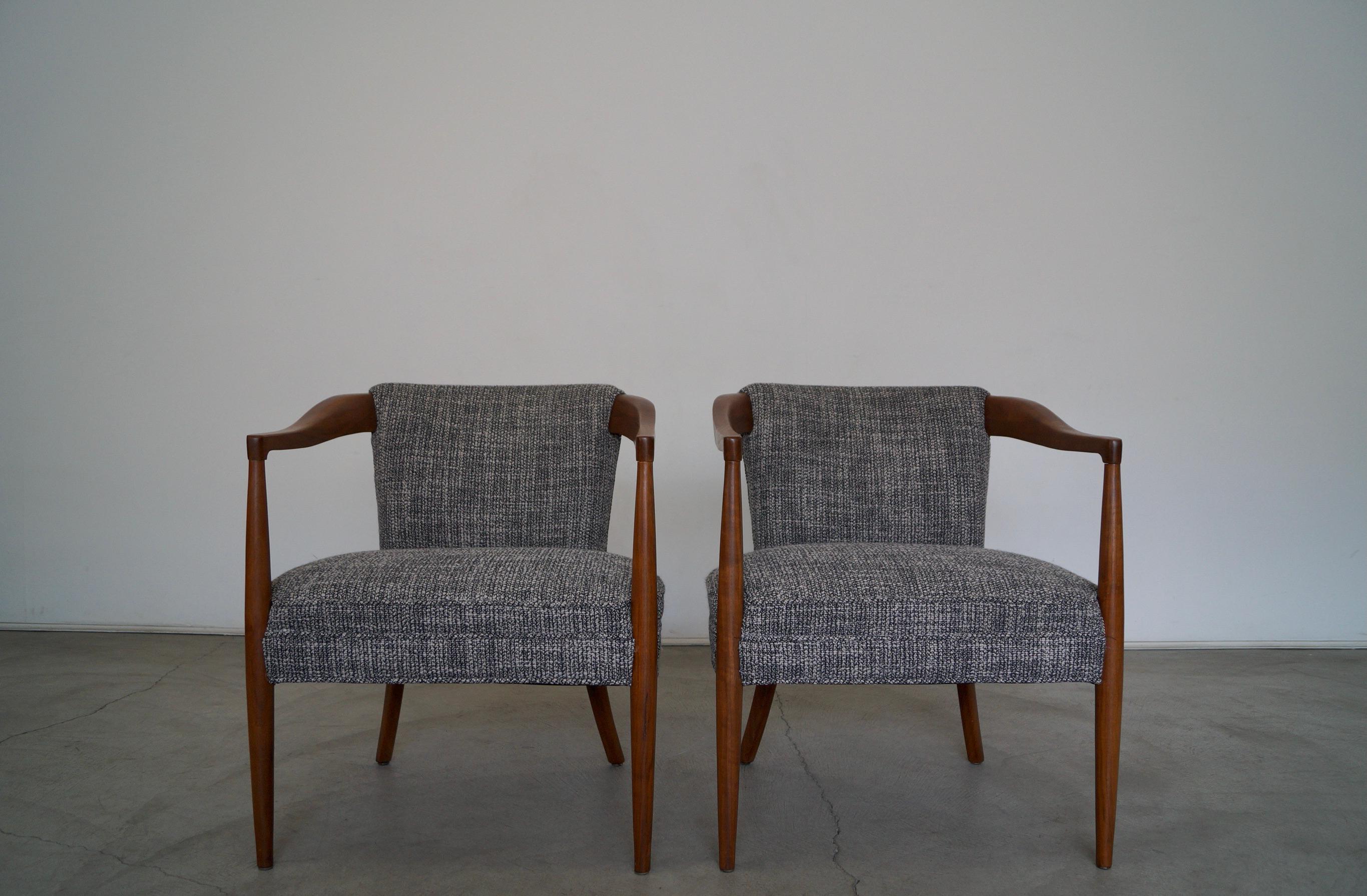 Pair of Mid-Century Modern armchairs for sale. From the 1950's, and have been professionally restored. They have been refinished and reupholstered in new fabric and foam. The frames are made of solid walnut, and have been refinished in natural