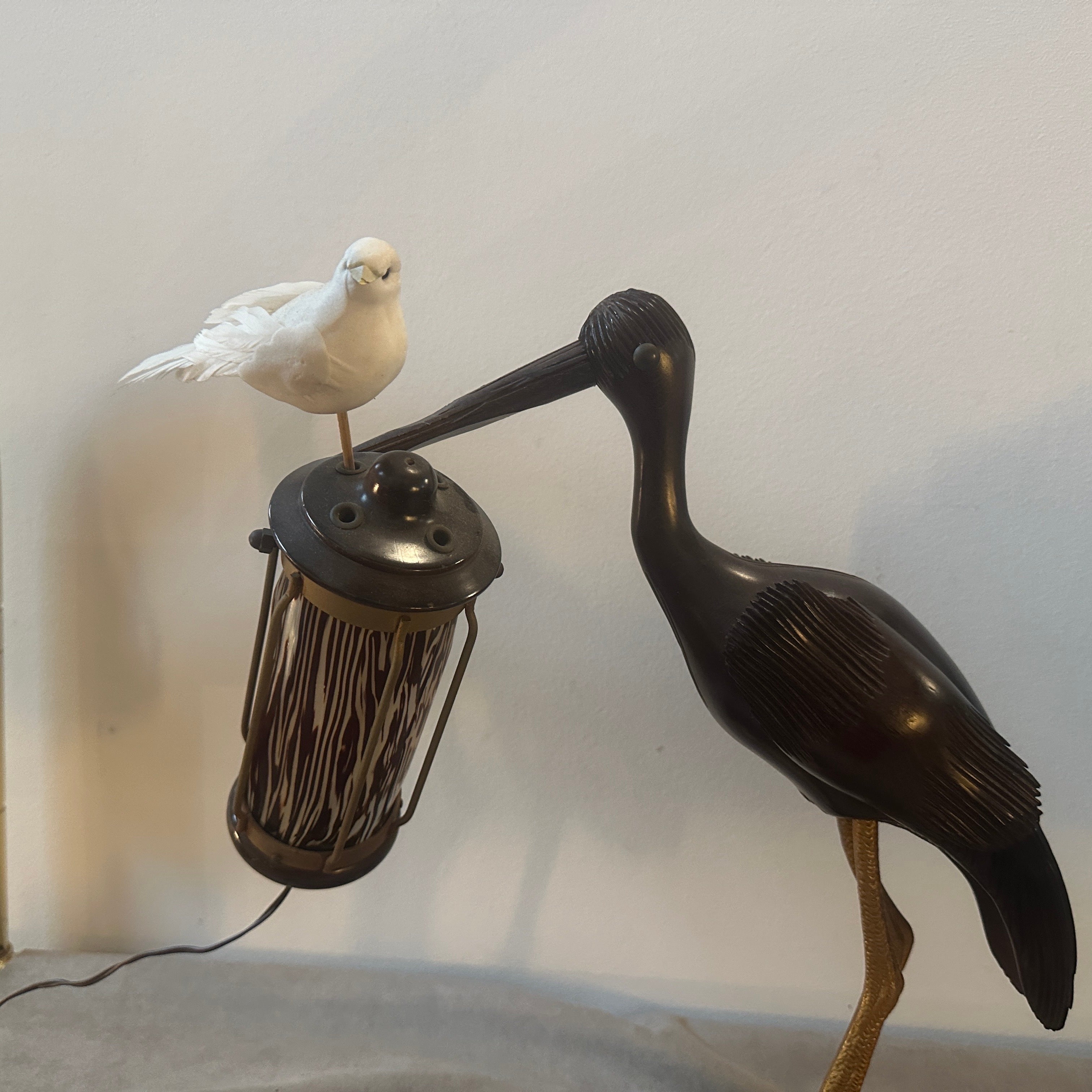 A wood and brass table lamp designed by Aldo Tura and manufactured by Macabo in the Fifties, the base of the lamp is also a smoking set. The wood sculpture depict an heron. the lamp has been rewired and it's in working order. In the 1950s, the