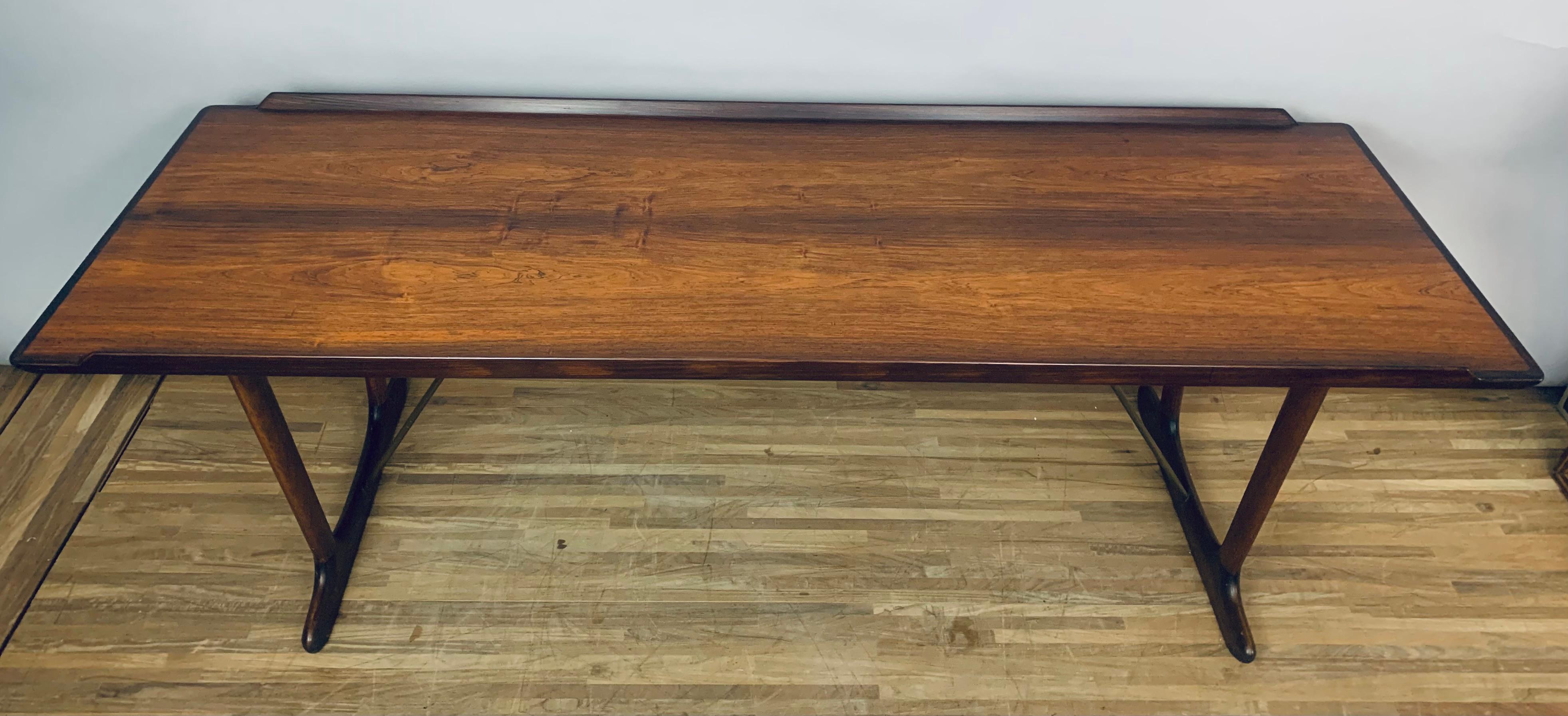 1950s Danish Rosewood coffee table designed by Arne Vodder for Vamo Sonderborg Pv.  The coffee table is stamped with the makers label underneath.  The table maybe a hybrid of two coffee tables because I've been unable to find one similar.  The table