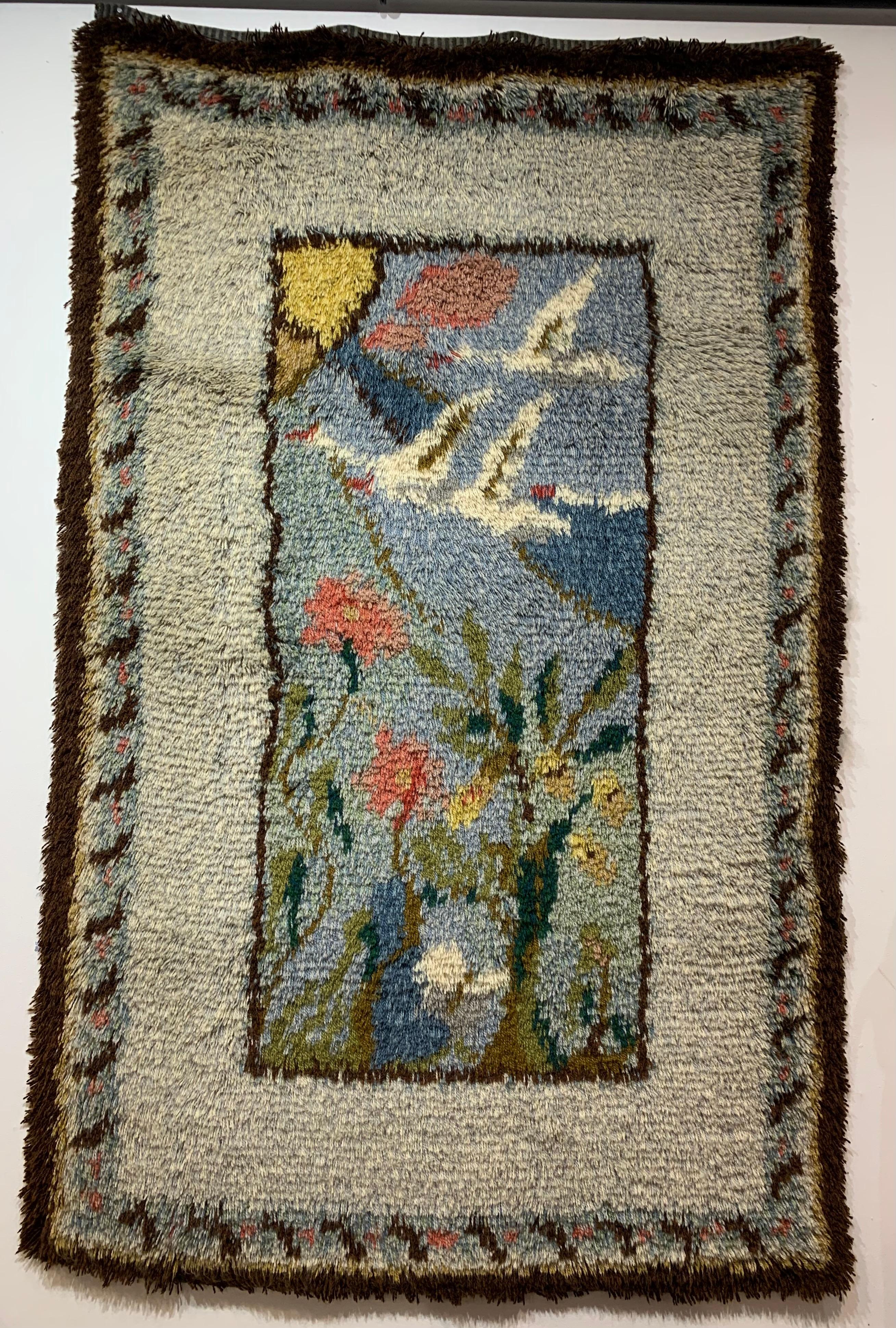 Mid century Scandinavian Rya rug which is loosely knotted but densely piled. This charming pictorial rug of flying migrating geese would work well on the wall or the bed. An excellent example of Scandinavian folk art which would work well in many