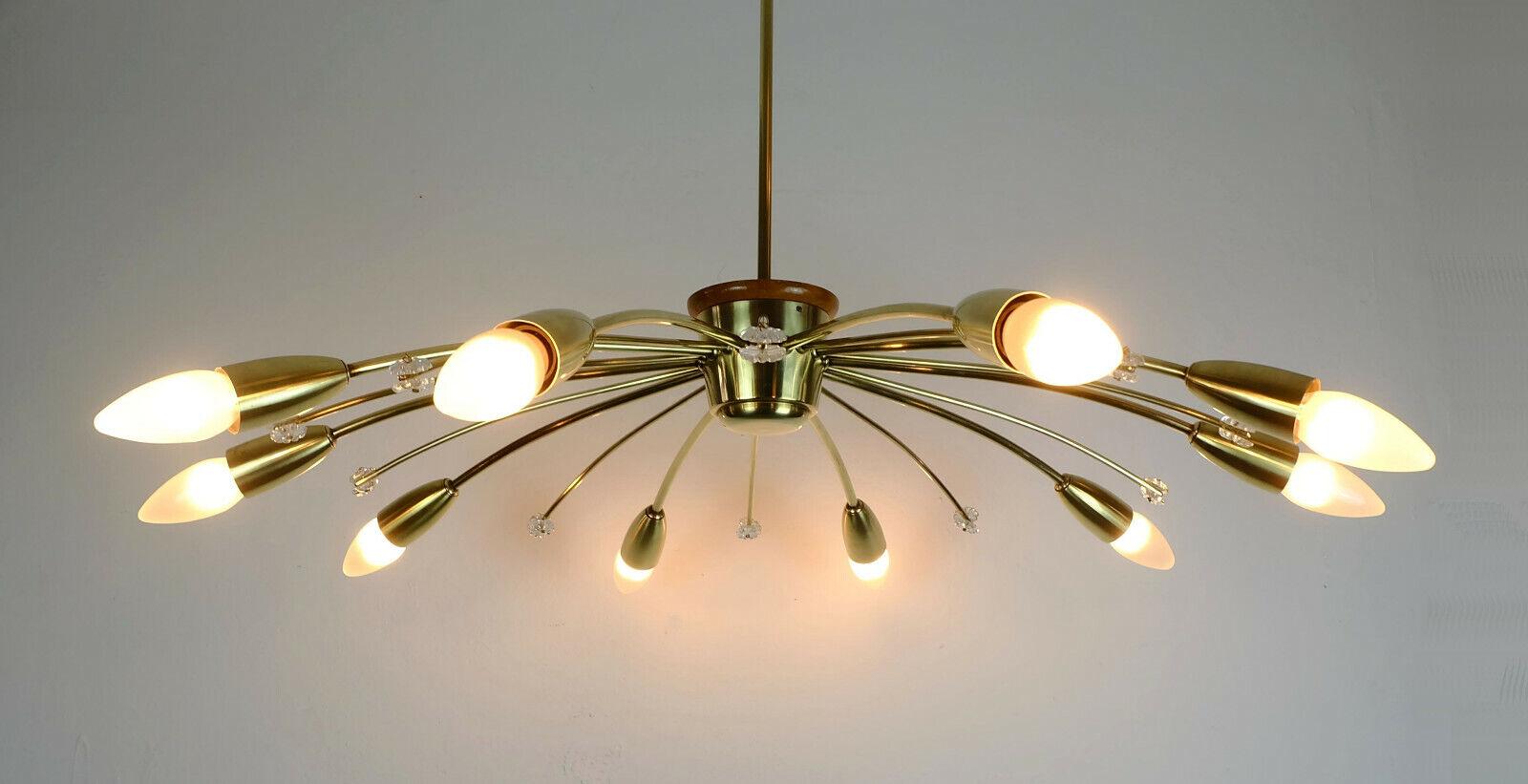 Very beautiful large 1950s ceiling lamp manufactured by Rupert Nikoll, Austria. Made of brass, the center part is made of lacquered wood. 10 arms, between each arm is a deco element with 2 small glass blossoms. Holds E14 bulbs (not included).

Very