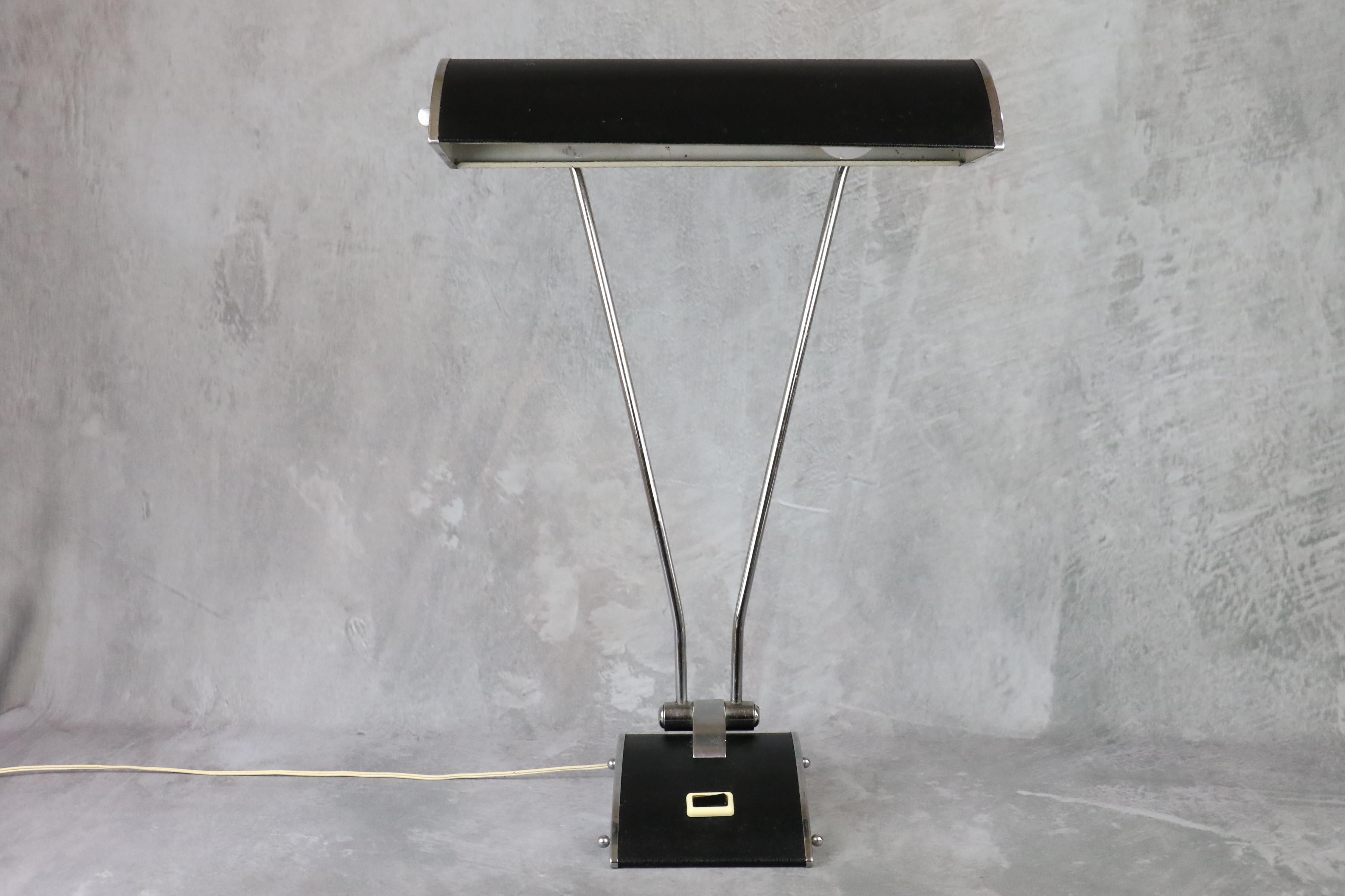 Beautiful black and silver Jumo lamp by Eileen Gray for JUMO. 
Circa 1950.  

With its chrome-plated arm and black moleskin-covered reflector, it's a very elegant design. 
Both arm and reflector are adjustable. 
It is in very good condition and