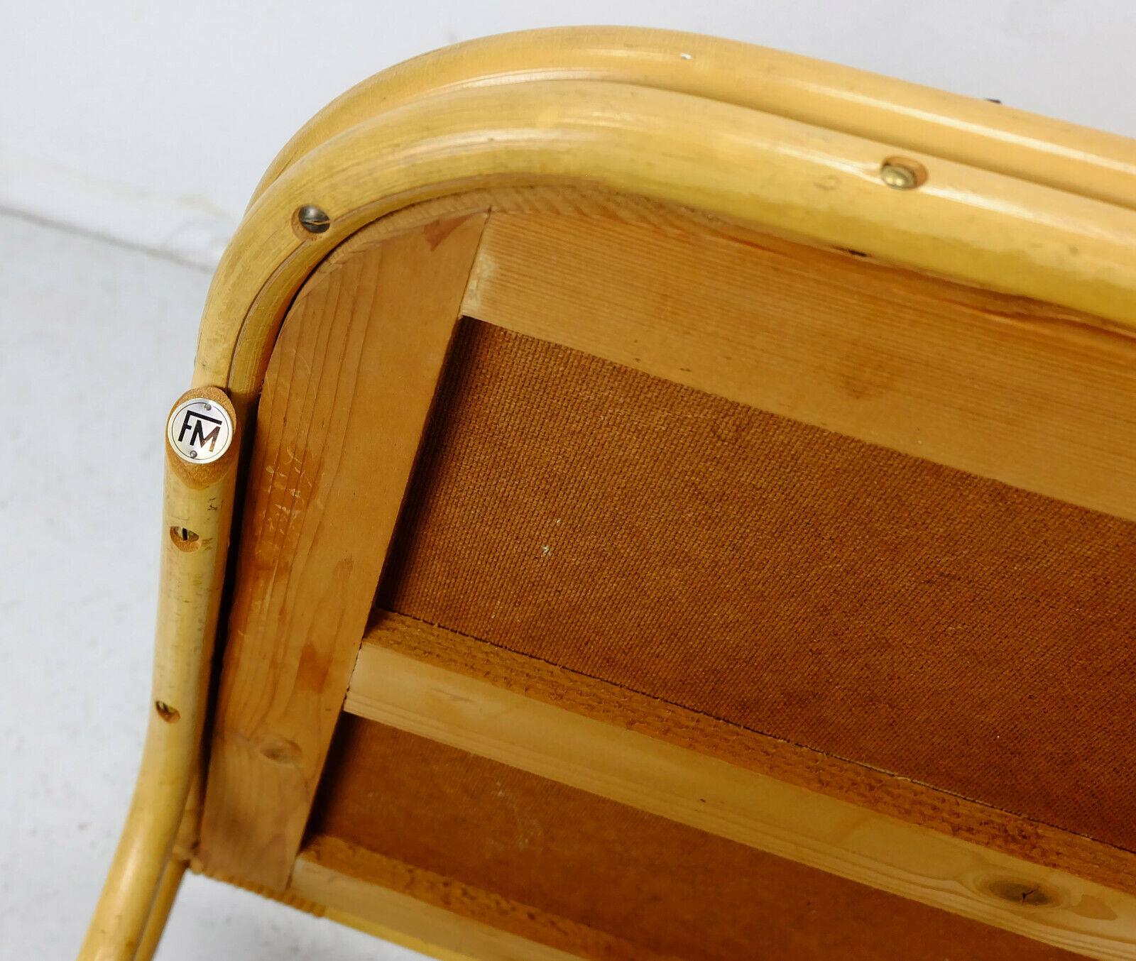 Very beautiful and decorative 1950s tea cart / serving trolley. The base is made of wood, bamboo and wicker, the shelves are covered with black formica with tile pattern. The wheels are made of rubber and brass. Holder for 4 bottles, magazine