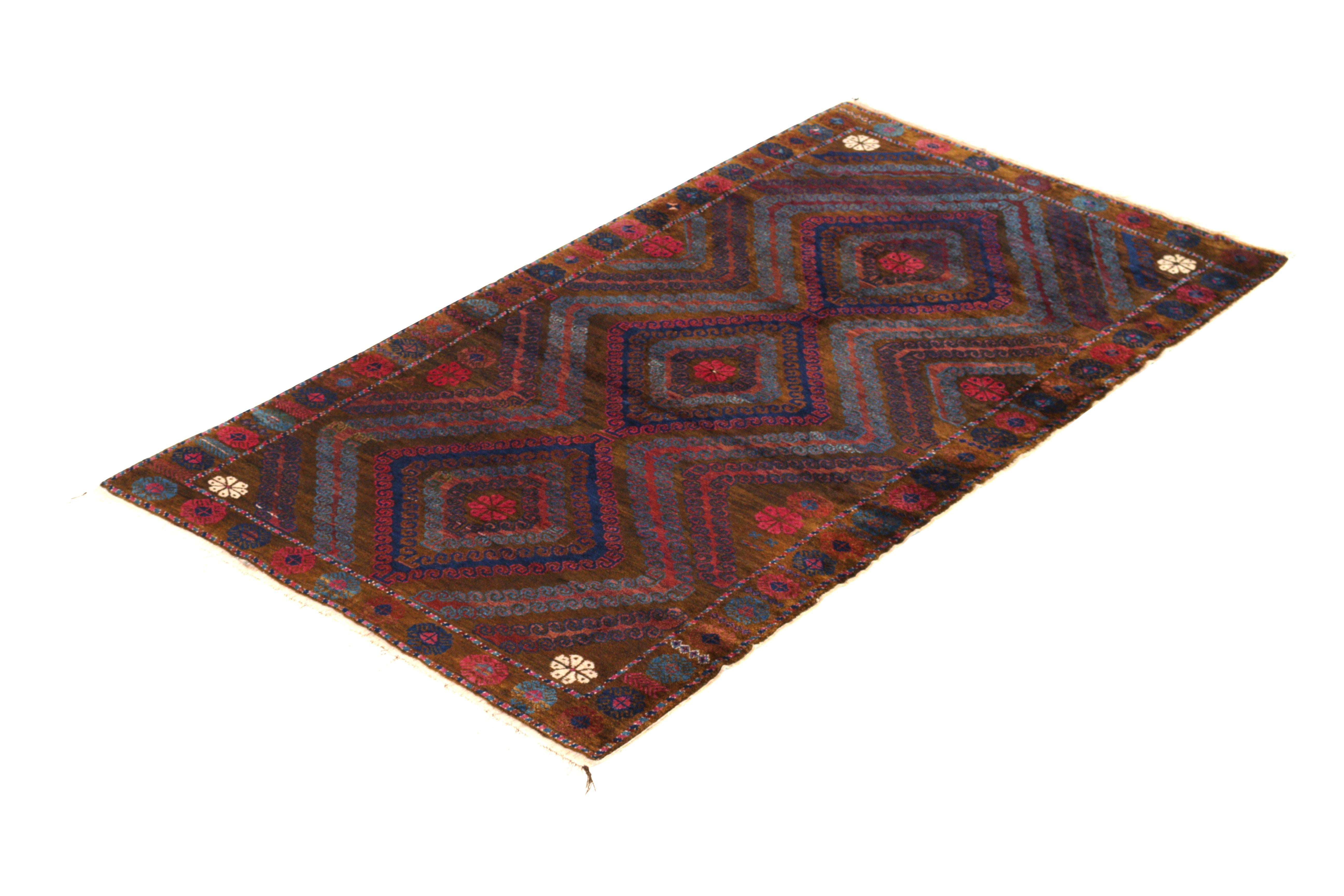 Hand knotted in wool originating circa 1950-1960, this vintage Persian rug connotes a midcentury Baluch tribal rug design with one of the most unique, appealing approaches to a transitional colorway we’ve seen among this antique lineage., enjoying