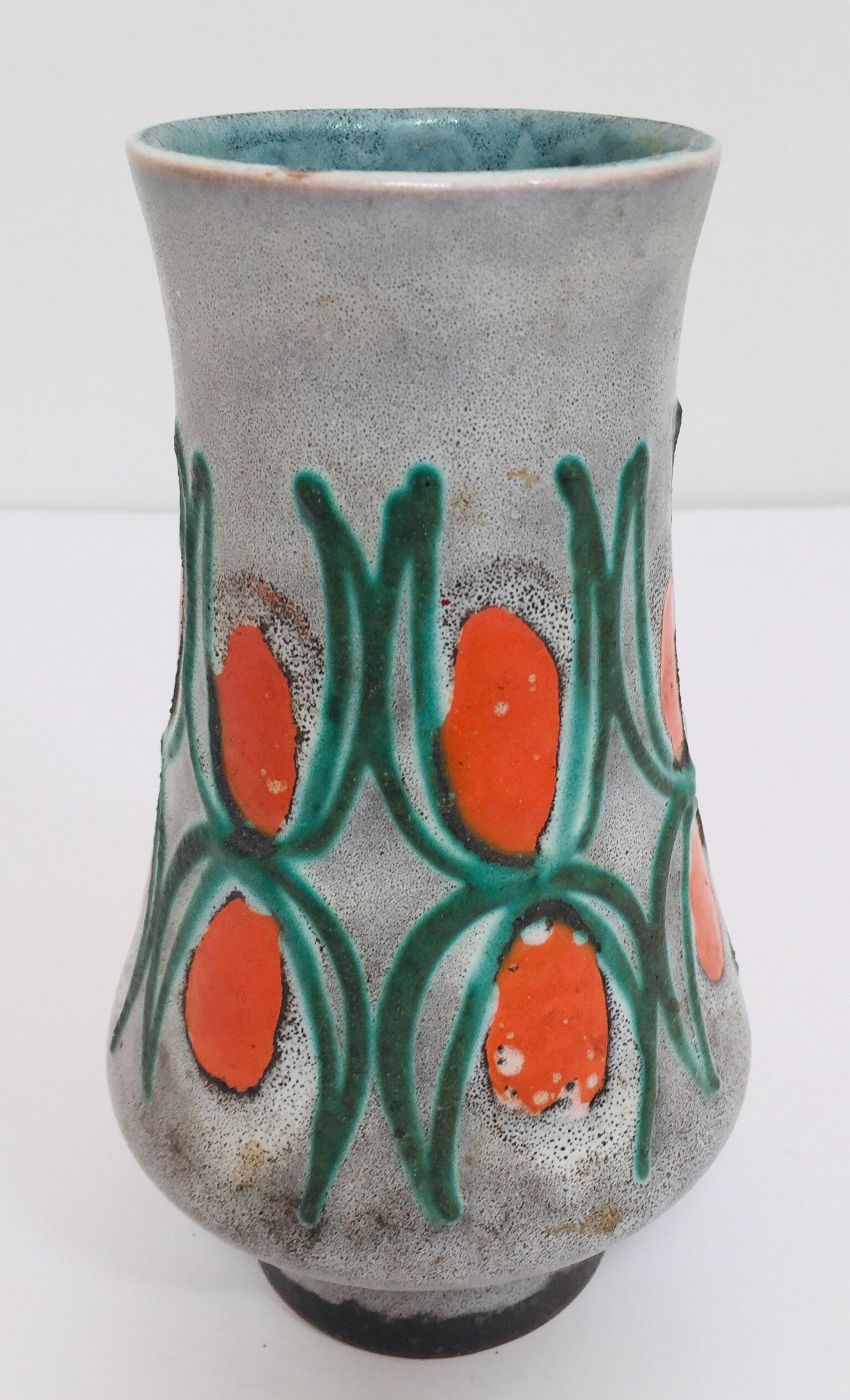1950s Ceramic Studio pottery vase, Germany Bauhaus.
Strehla East Germany, 1950 ‘GDR’ ceramic vase.
Vibrant vase in a grey with orange, red, charcoal lava glaze finish.
Straightforward and minimalistic design of the 1950s Bauhaus design era.
This