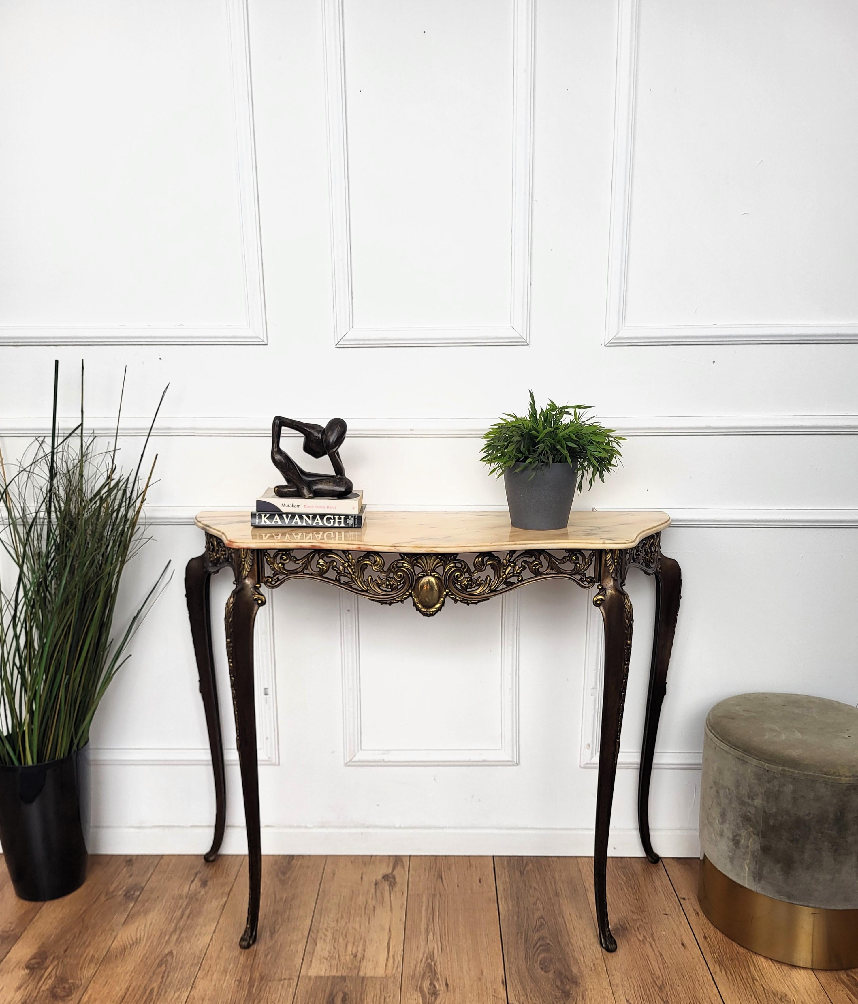 Very elegant and refined Italian 1950s Mid-Century Modern in baroque neoclassical design console table. The stunning brass decorated structure and shaped legs with its typical marble beveled top give this console an extremely light and open