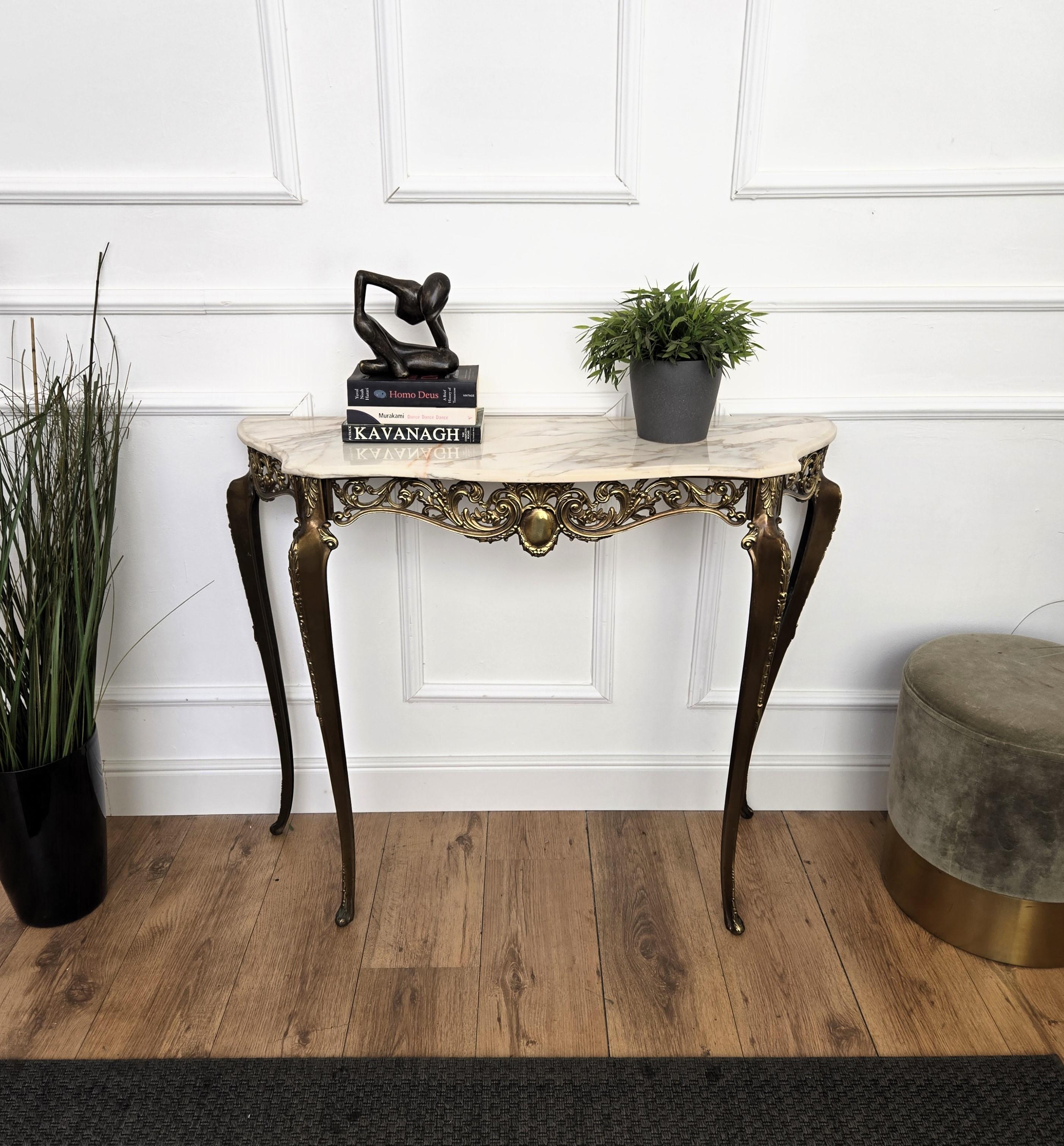 Very elegant and refined Italian 1950s Mid-Century Modern in baroque neoclassical design console table. The stunning brass decorated structure and shaped legs with its typical marble beveled top give this console an extremely light and open