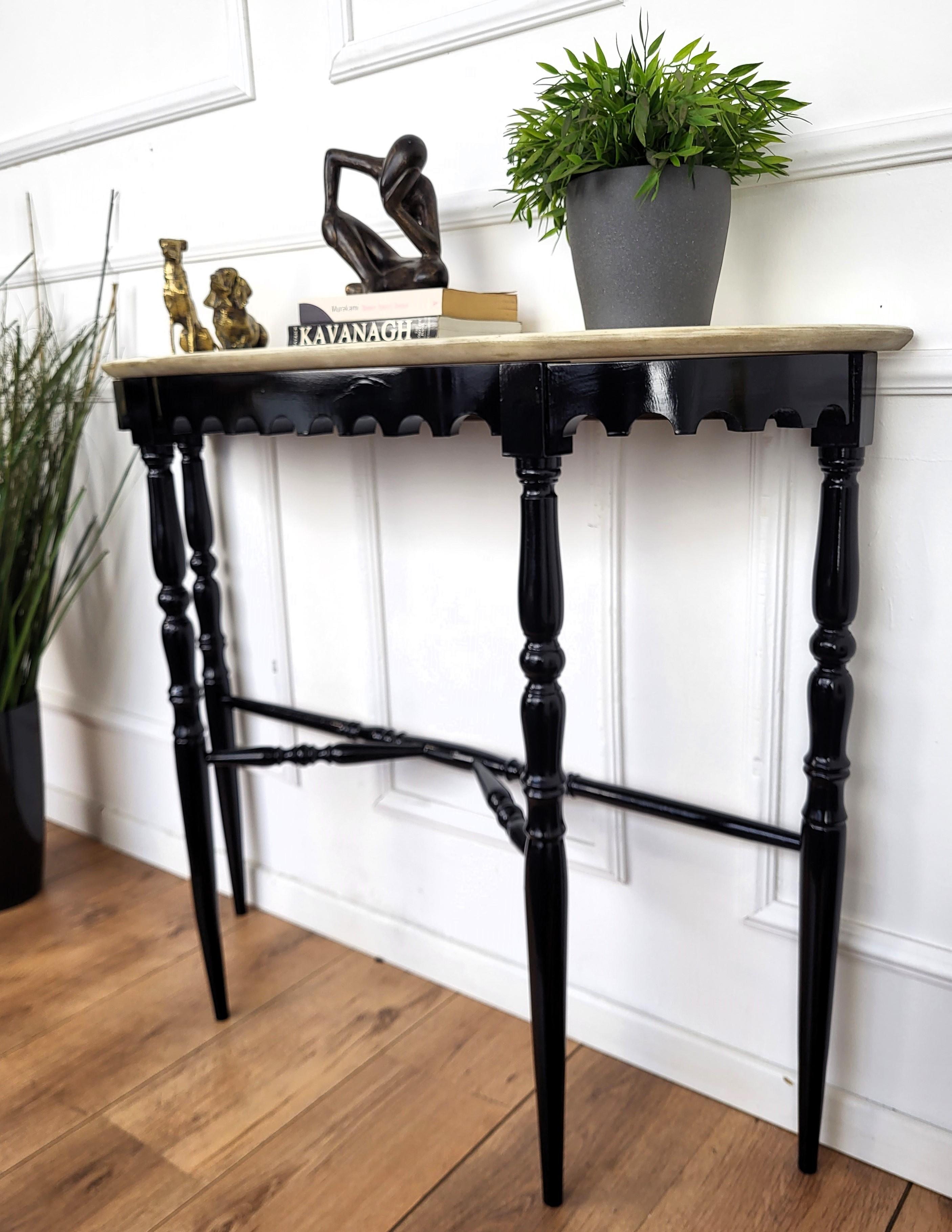 Very elegant and refined Italian 1950s Mid-Century Modern and neoclassical design console table. The four stunning carved shaped legs connected by central stretcher and with its typical white Carrara marble top give this console an extremely light