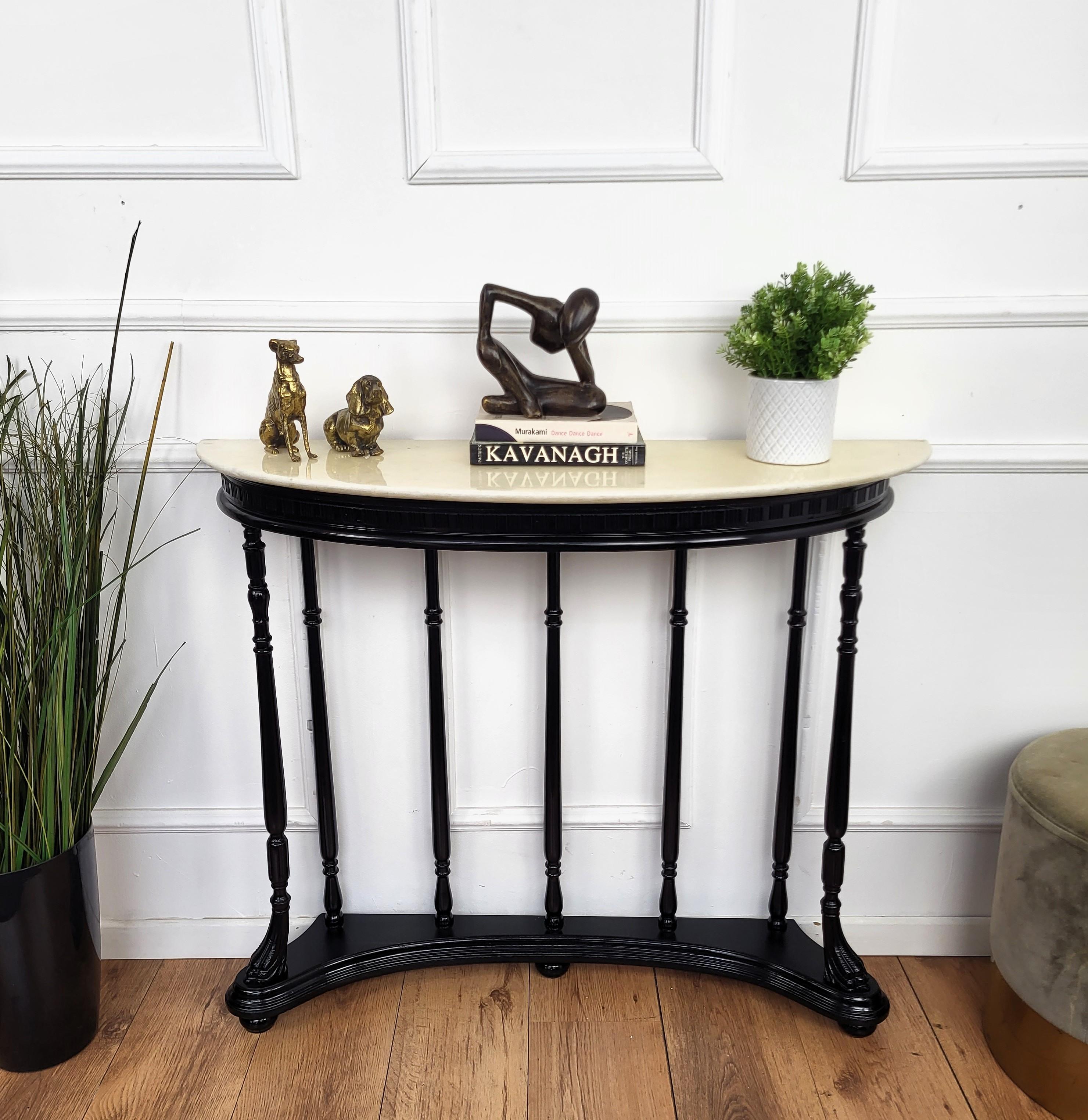Very elegant and refined Italian 1950s Mid-Century Modern and neoclassical design console table. Characterized by the stunning carved and shaped legs connected by the bottom stretcher and with its typical white Carrara marble demi-lune top give this