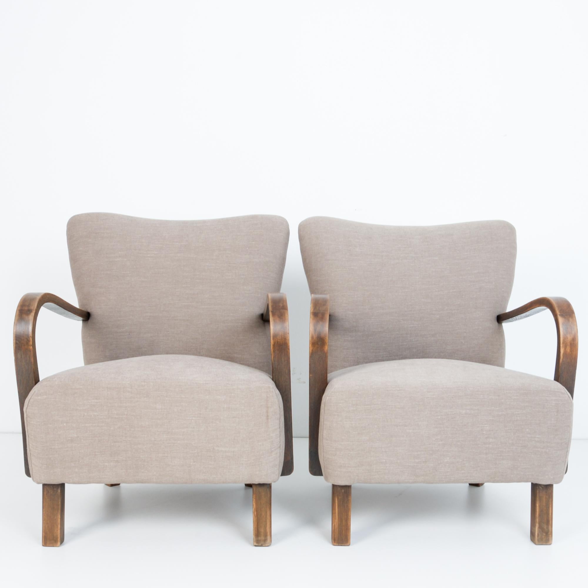 From Czech Republic circa 1950 a comfortable and stylish pair of upholstered armchairs. In typical mid-20th century Modernist style, a timeless approach that still looks contemporary and fresh. This chair features distinctive geometric frame from