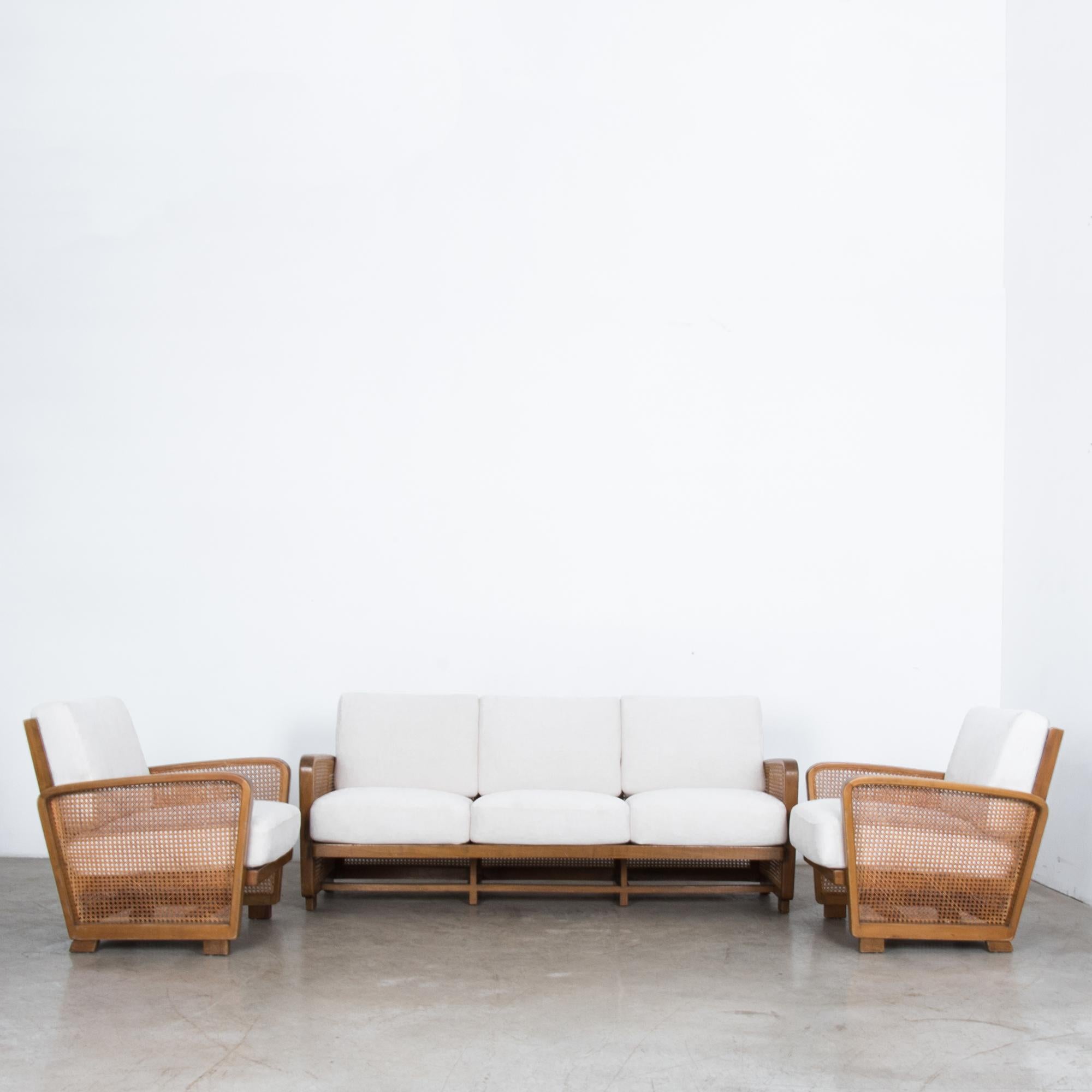 From Germany, circa 1950 this three piece sofa set includes a three seat standard sofa and two armchairs in beech wood and woven straw. A typical mid-20th century German design, simple forms from natural materials, the whiff of Bauhaus still in the