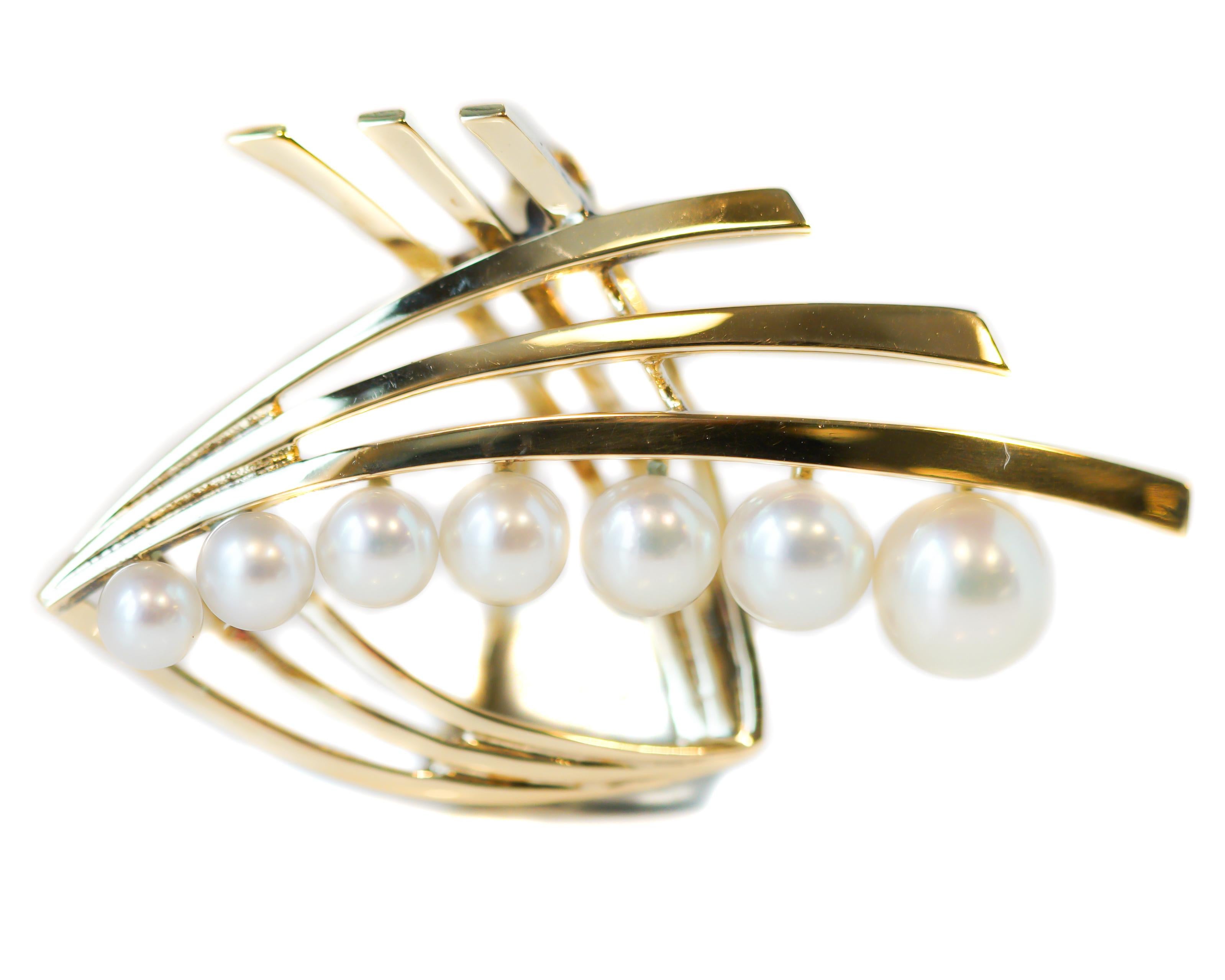 Mikimoto Pearl Brooch - 14 Karat Yellow Gold, Pearls

Features:
7 lustrous white round Pearls
14 karat Yellow Gold
Pearls measure 6.5 - 3.75 millimeters
Brooch measures 41 x 28 millimeters
Hallmark M.K14 on back of gold strand

Brooch