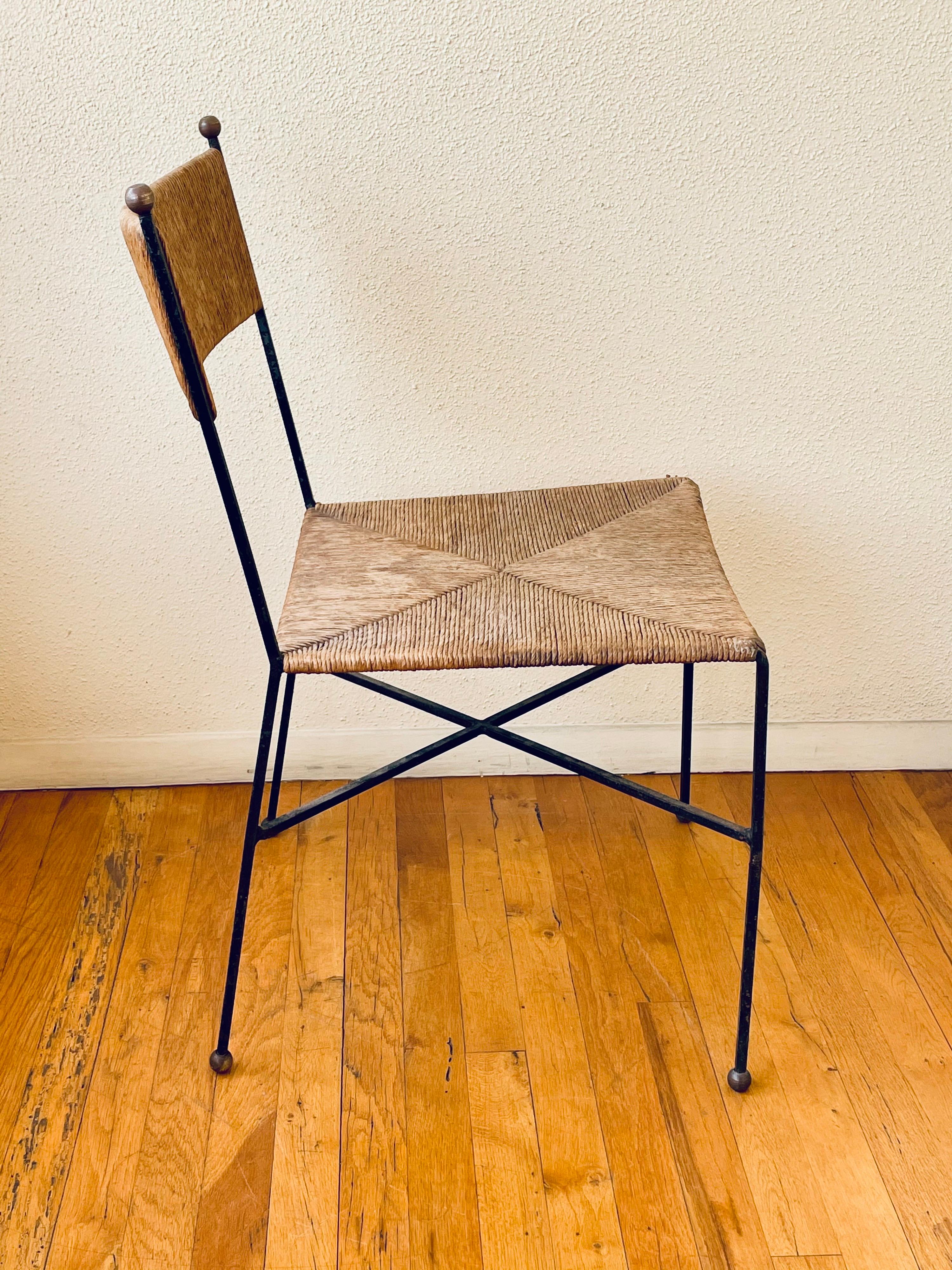 Milo Baughman for Murray Furniture wrought iron and rush side chair, circa 1954. Featuring a rounded rush back, rush seat, wrought iron frame with crisscross supports, and brass ball details. Very good vintage condition. Comfortable. Versatile.