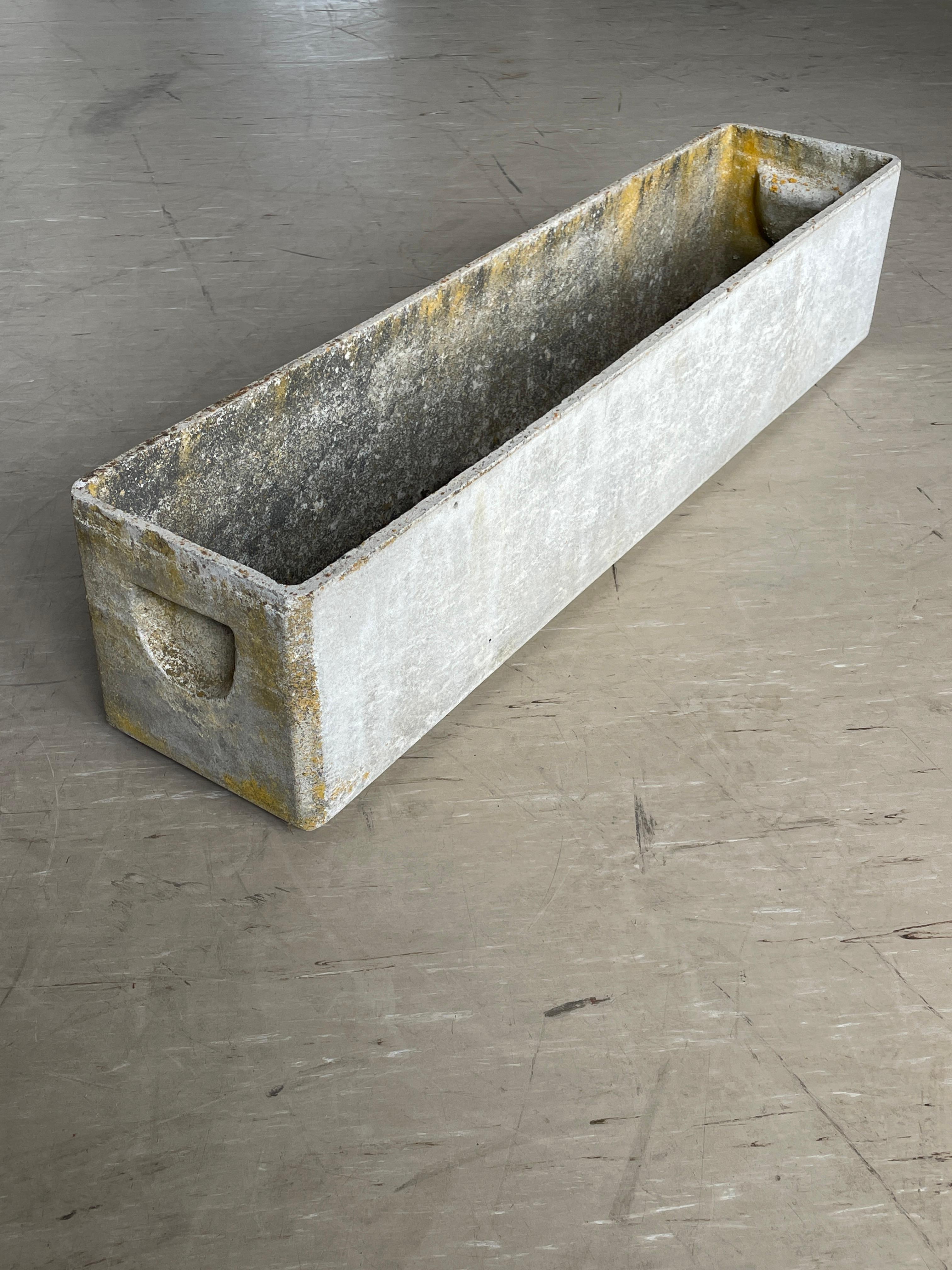 Minimalistischer Beton-Pflanztrog des bekannten Schweizer Designers Willy Guhl. Hergestellt in der Schweiz ca. 1950 - 1960. Produziert von Eternit AG, Schweiz. Massiver Beton mit Entwässerungslöchern. Mit originalen versenkten Griffen.
In originalem