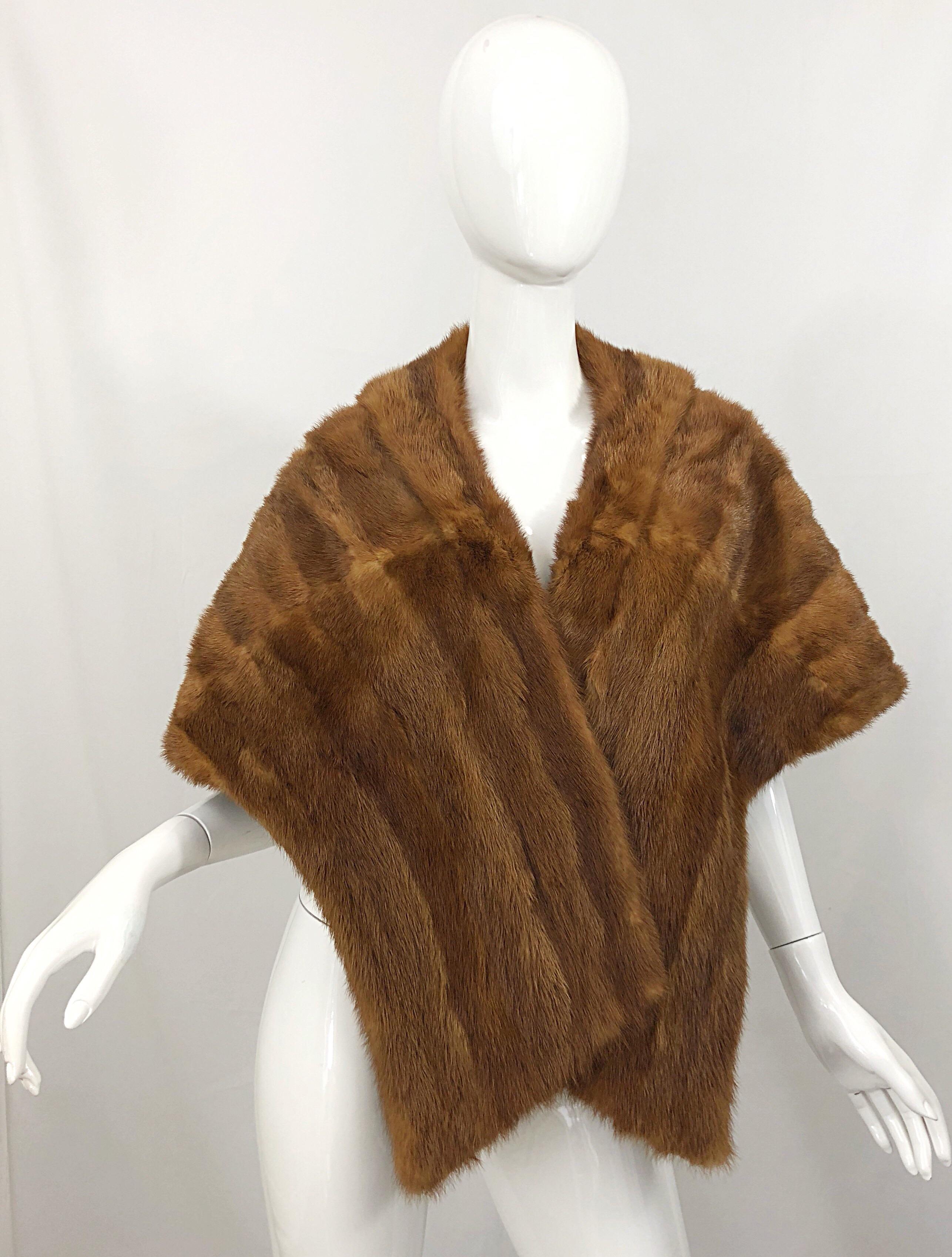 Luxurious 1950s light brown (pastel) large stole wrap! Super soft mink fur that will keep you warm while looking stylish. Lined in taupe silk, with a pocket. Extremely well made and kept. 
Classic addition to any wardrobe. Great over a dress or