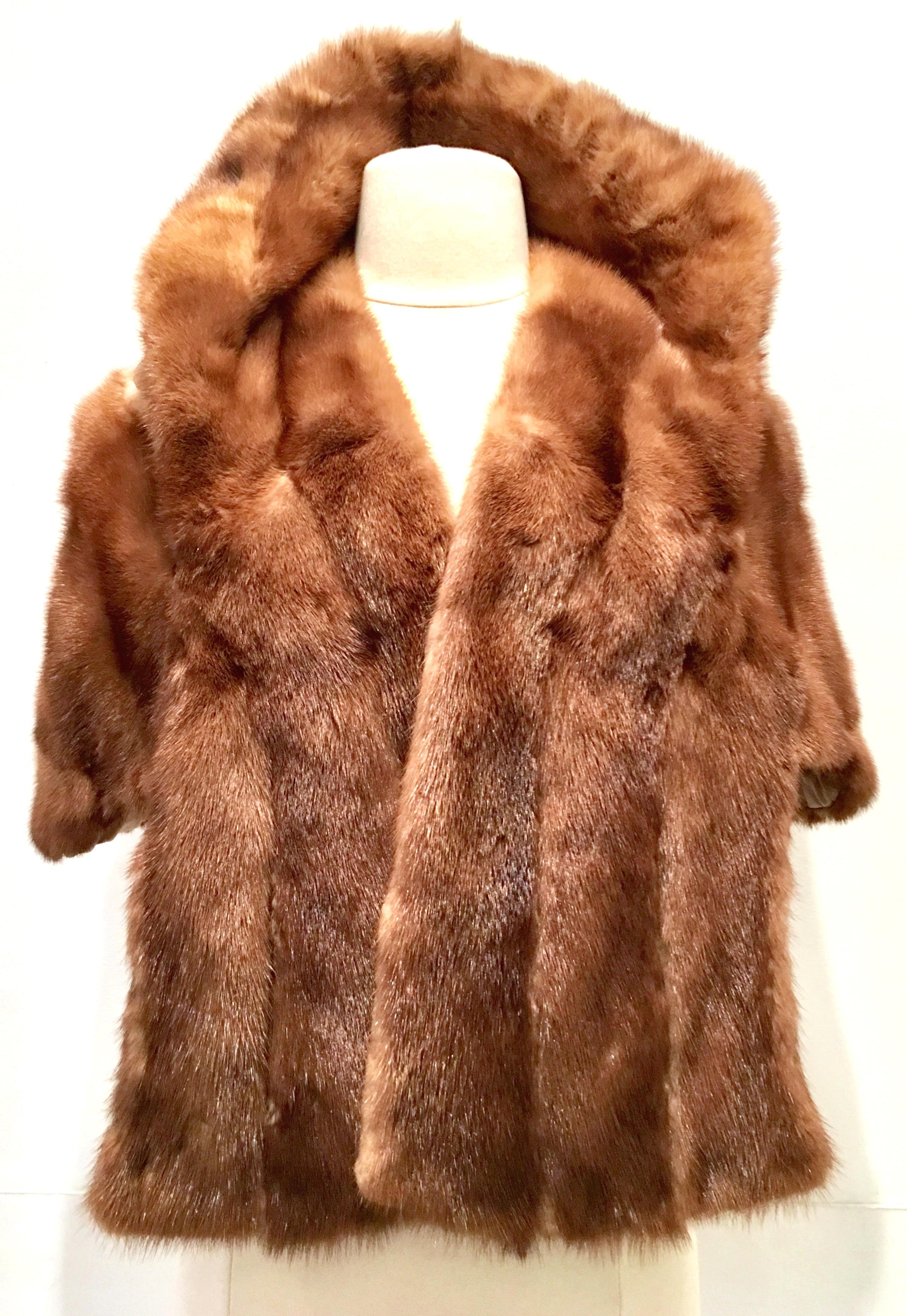 1950'S Mink Fur Capelet By, Lloyd's Fur-Denver. This soft and brilliant brown mink capelet features two side pockets with a roll over adjustable petal hem detail collar. Fully lined and maintains the original furrier label at the interior neck. One