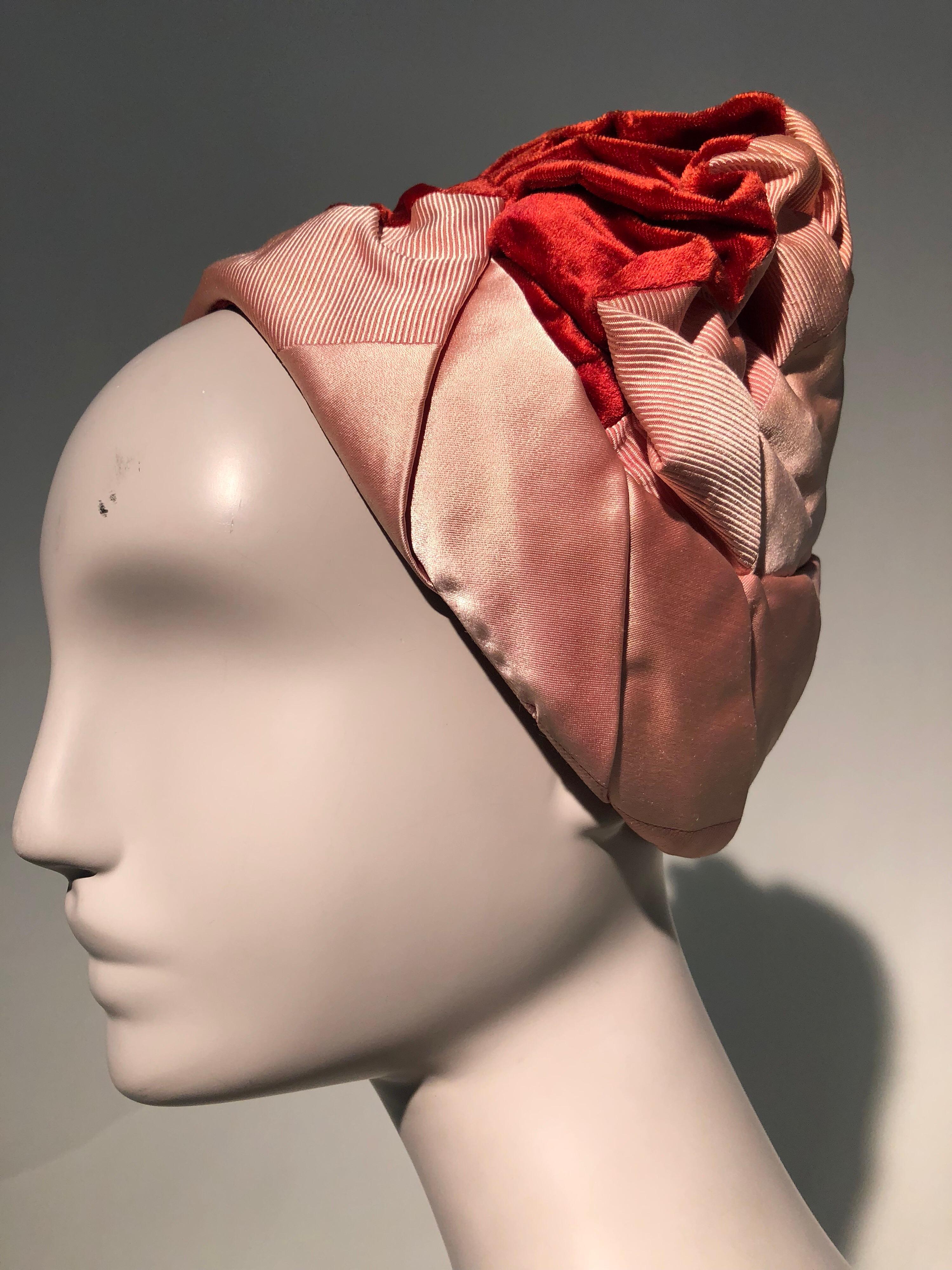 A wonderful 1950s Miss Dior turban-style hat by Christian Dior in red velvet, pink satin and faille. A row of soft gathers at crown lends this hat a lovely volume. Base is stiffened lace. 
