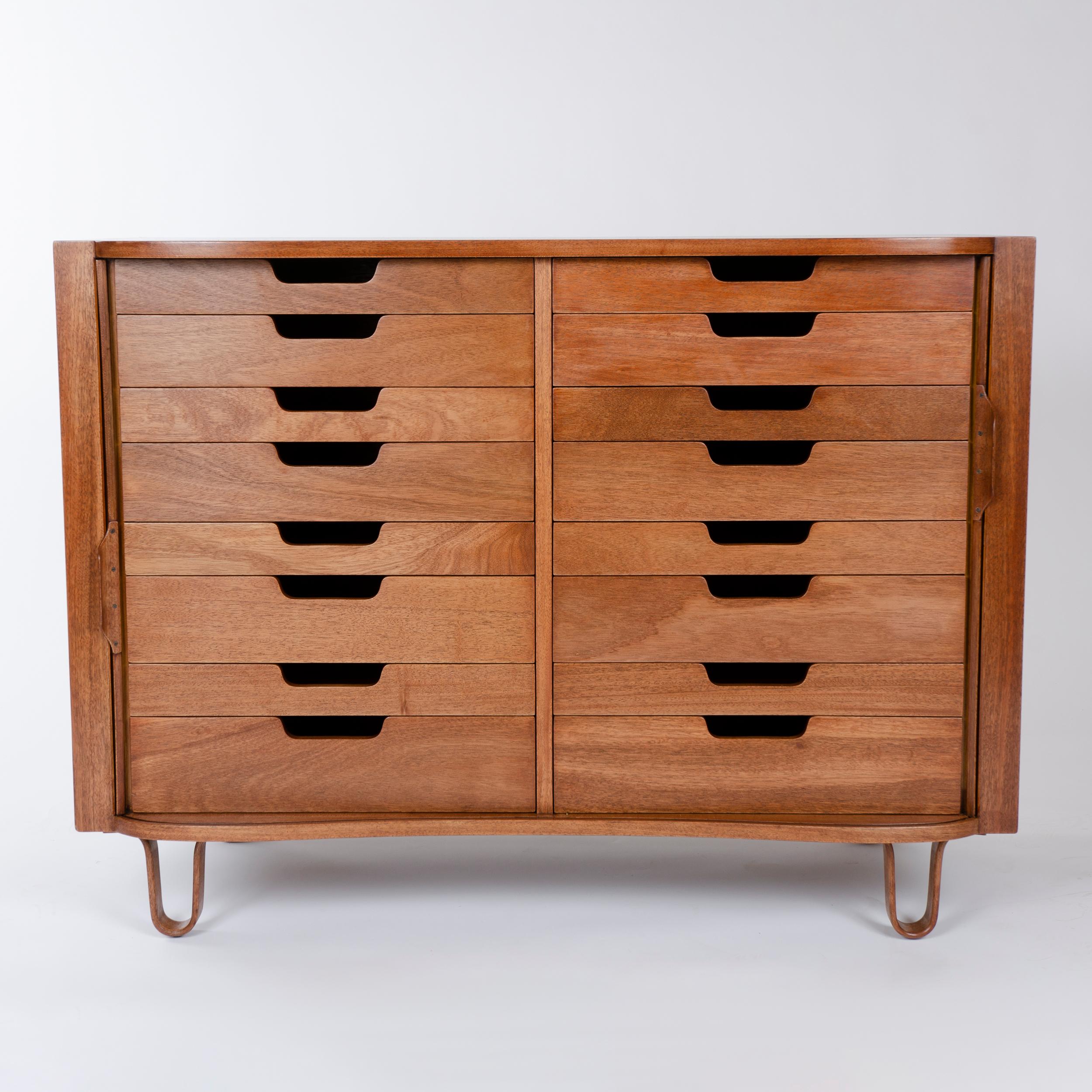 A superb mahogany tamboured mister cabinet with an undulating face, expressive hairpin legs and a useful sixteen drawer configuration.