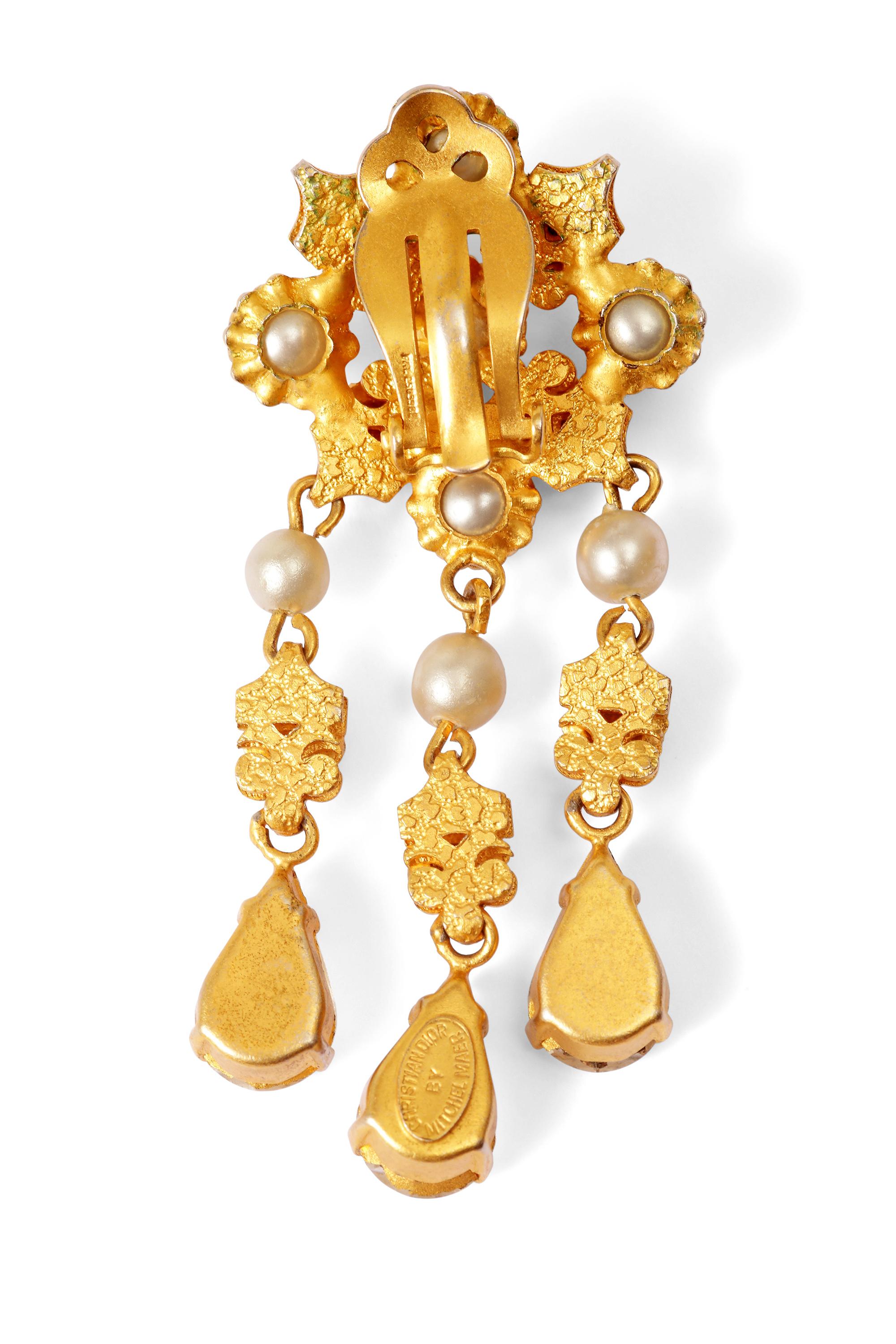 These sensational 1950s crystal teardrop earrings are by Mitchel Maer for Christian Dior and are in superb vintage condition. Each piece is comprised of gold tone metal fashioned into an ornate cluster of prong set crystal rhinestones and
