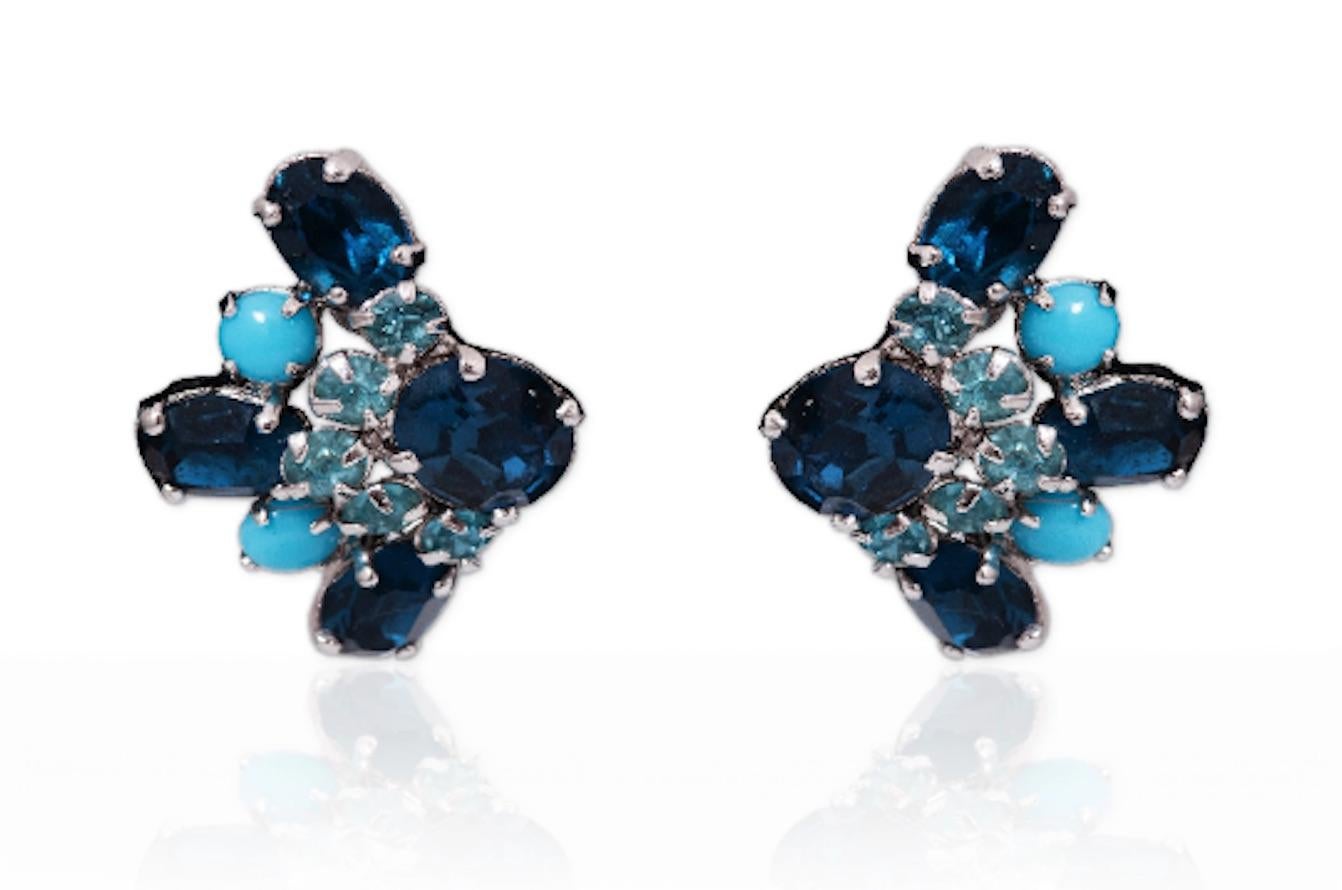 Early and original 1950s Christian Dior earrings designed by Mitchel Maer between 1952 and 1956.  The design of the earrings is shaped like an arrow and set around a double colour combination of faux turquoise and sapphire blue crystal. The metal