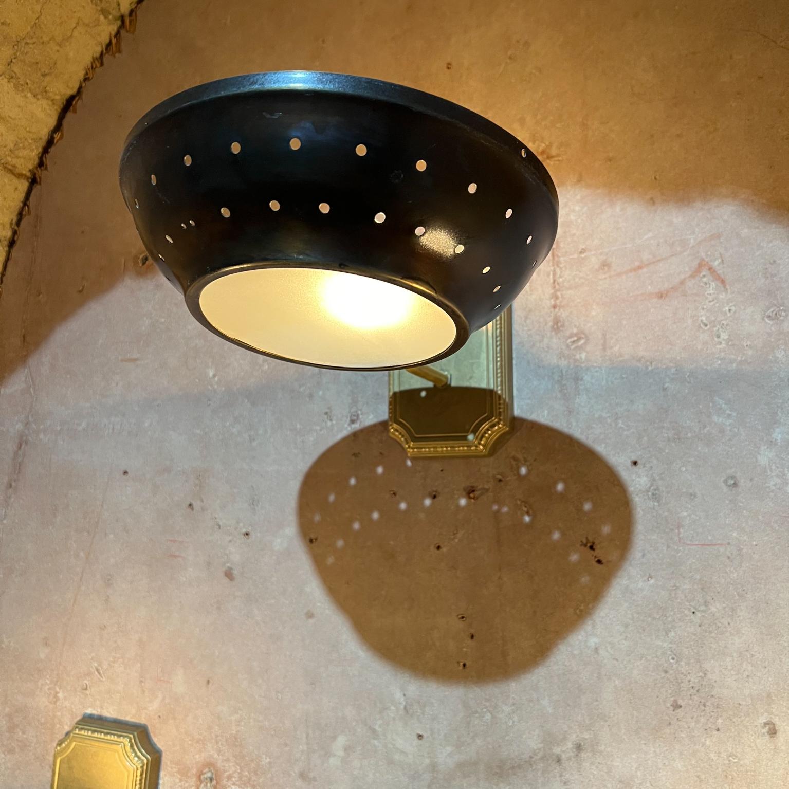 1950s Modern Atomic three patinated brass wall sconces perforated round saucer dish shade
Lamps are in patinated brass with frosted glass
Provides for a lovely light display
12 deep x 8.5 wide x 6.5 tall
Preowned original unrestored vintage