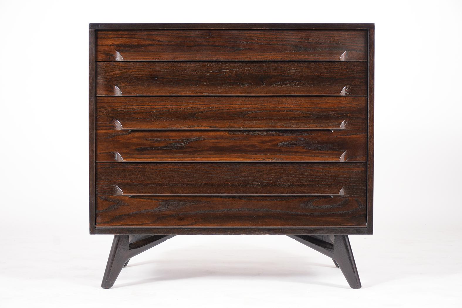 This is a 1950s chest of drawers by Jack Van der Molen for New York Furniture Exhibit Corp has been newly restored and is in great condition. The dresser is made out of teak wood stained in a dark color satin with a lacquered finish and features