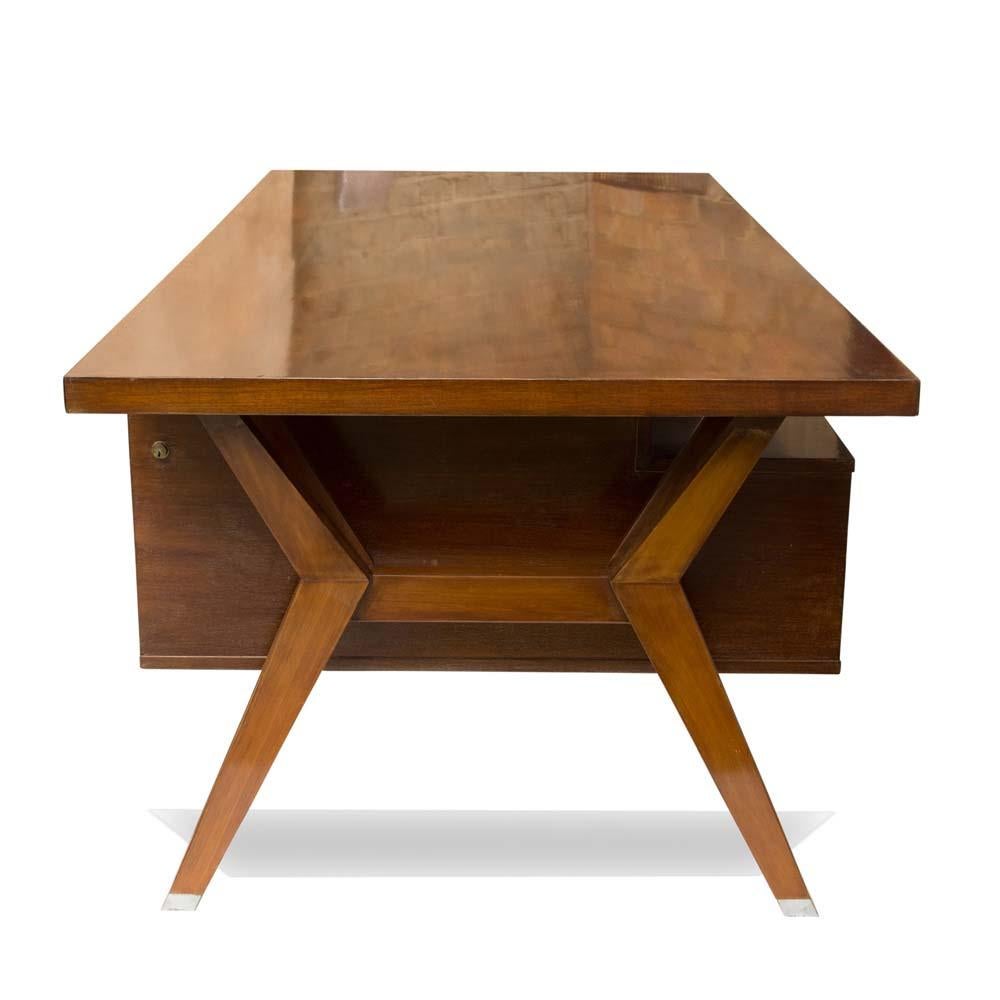 A very beautiful 1950 presidential desk. Modernist, dark polished wood with steel inserts.
This is a versatile desk which allows one to make use of both drawers, or detach it from the structure. the wood is rosewood . This is a very comfortable